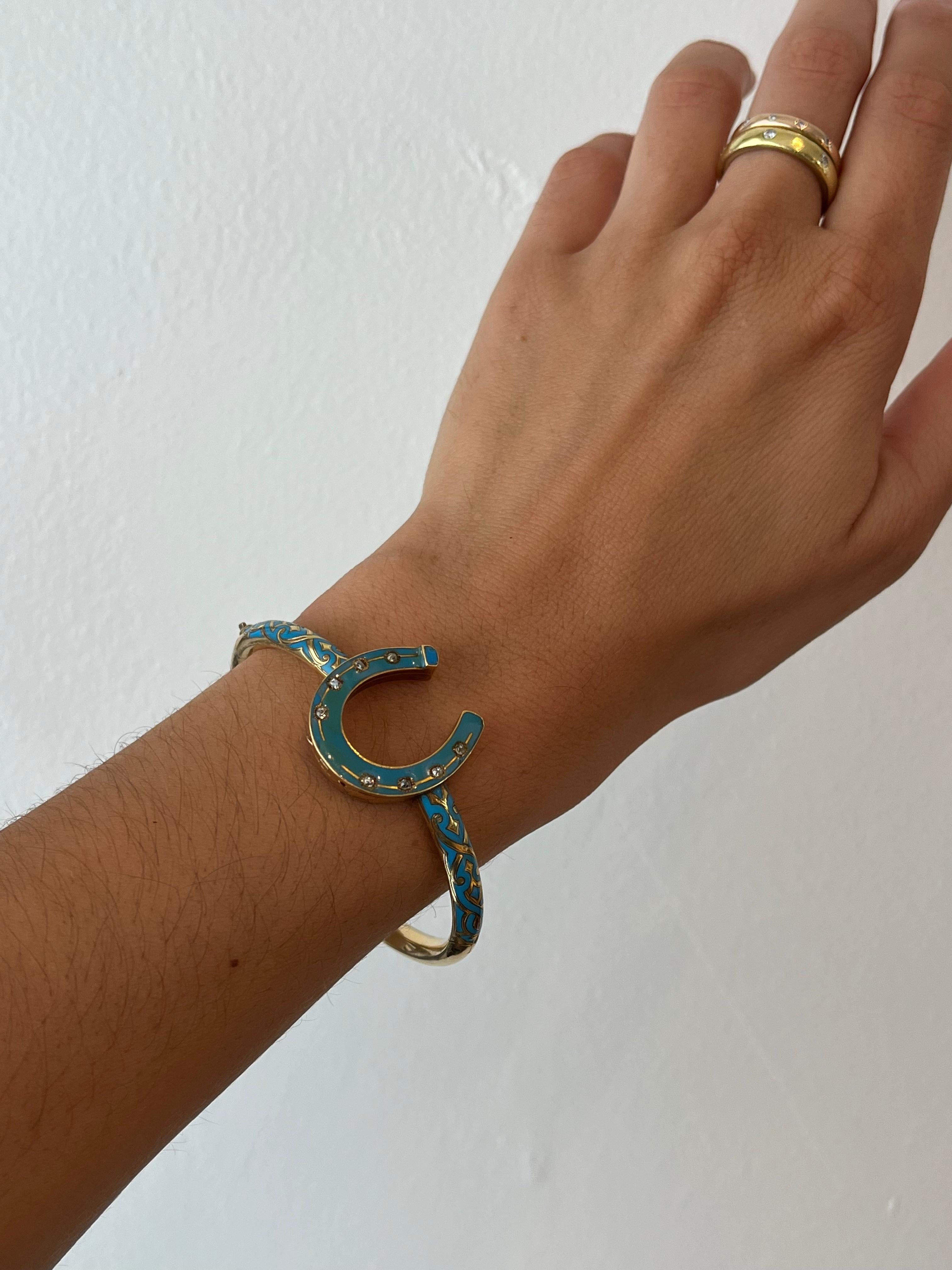 The horseshoe that is the center design of this antique 14K cuff bracelet, is a known symbol of good luck and protection. The added intrigue of this circa 1880s piece is that the horseshoe is a locket. Decorated with turquoise blue enamel and 8
