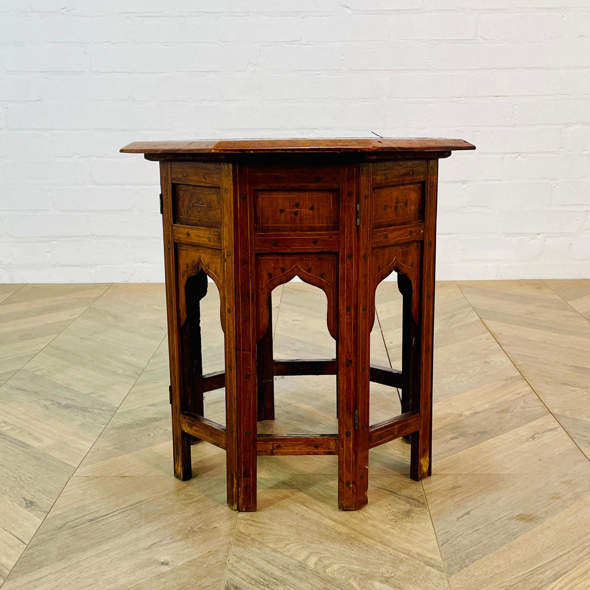 Antique Anglo-Indian Octagonal Hoshiarpur Table with Beautiful Brass Inlaid Decorations to the top and side. Circa Early 1900s.

The table , which has a folding base is in good antique condition, but does show small signs of wear to the top and