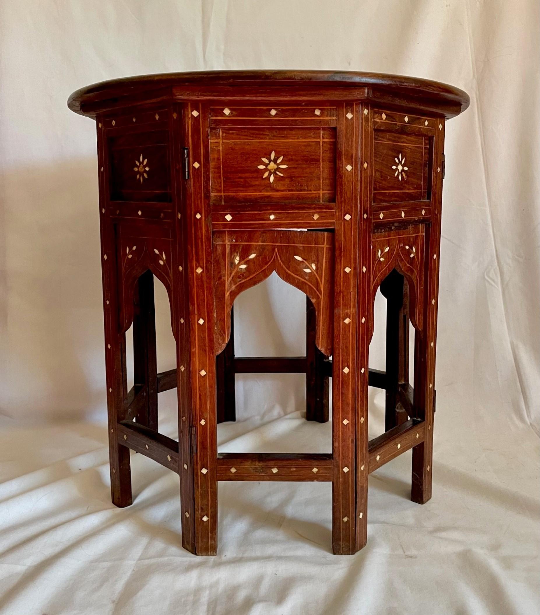 Antique Hoshiarpur inlaid octagonal folding side table, circa 1890.

Late 19th century octagonal Hoshiarpur table with intricate bone inlay. The top has an elaborate image of a Peacock inlaid with bone and is surrounded by bone inlay floral and
