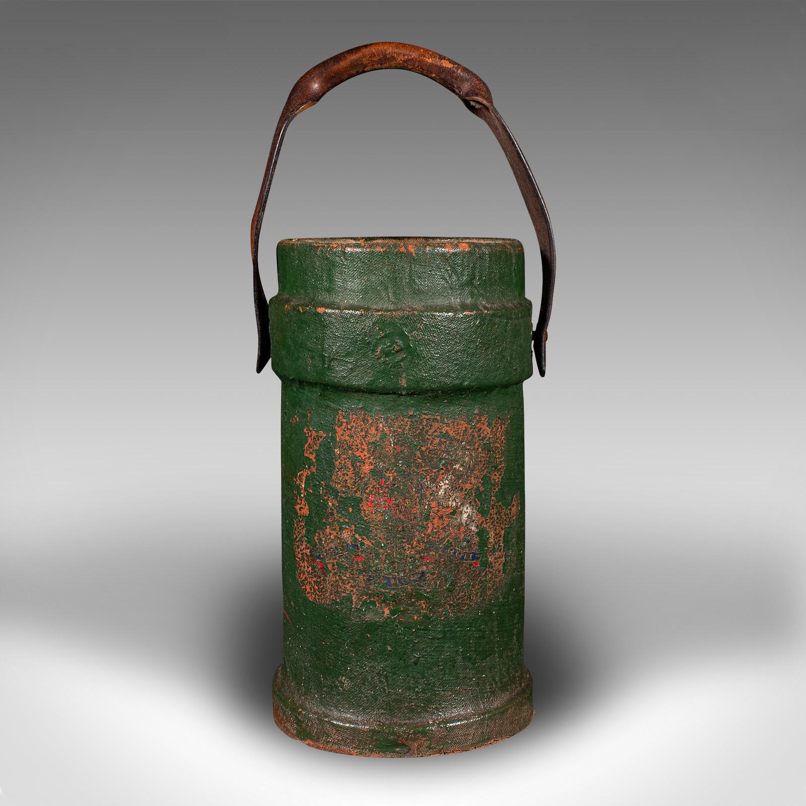 This is an antique household carry. An English, waxed canvas and leather log or storage bucket, dating to the late Victorian period, circa 1900.

Distinctive weathered appearance, and of versatile form
Displays a desirably aged, original patina