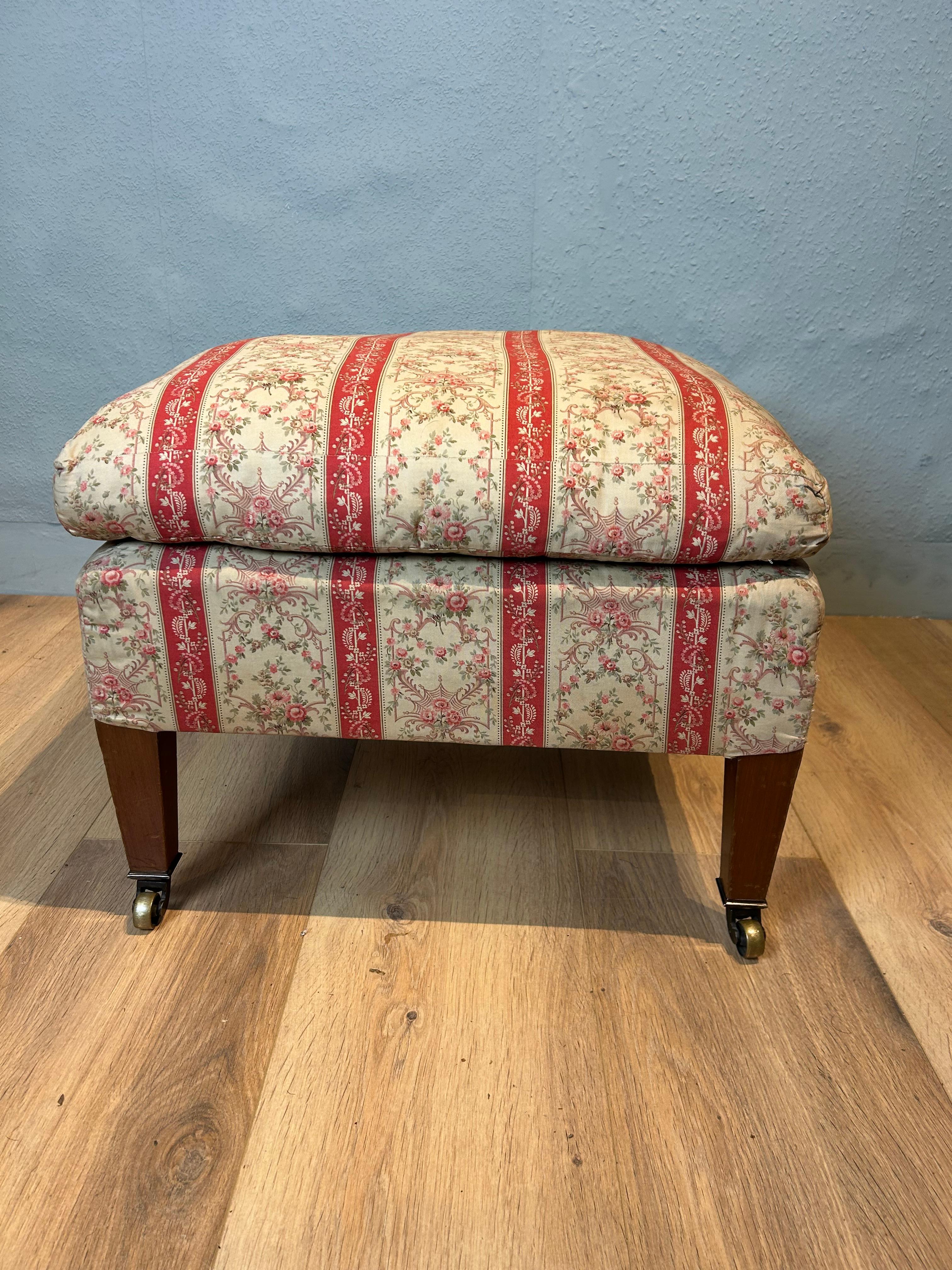 English country house upholstered stool made by the esteemed company Howard & Sons in original untouched condition retaining its first used Howard design frabric, the square tapered mahogany leg is stamped HOWARD & SONS LTD BERNERS ST with two sets