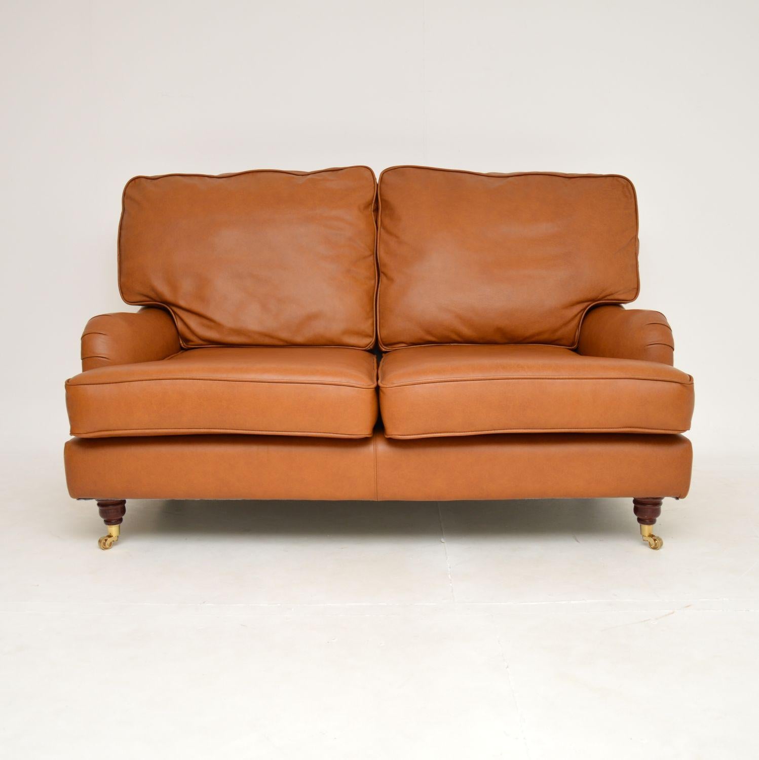 A fantastic leather two seat sofa in the antique Howard style. This was made in England, it dates from the late 20th century.

The quality is excellent and this is extremely comfortable to relax in. It is well padded and supportive, the tanned