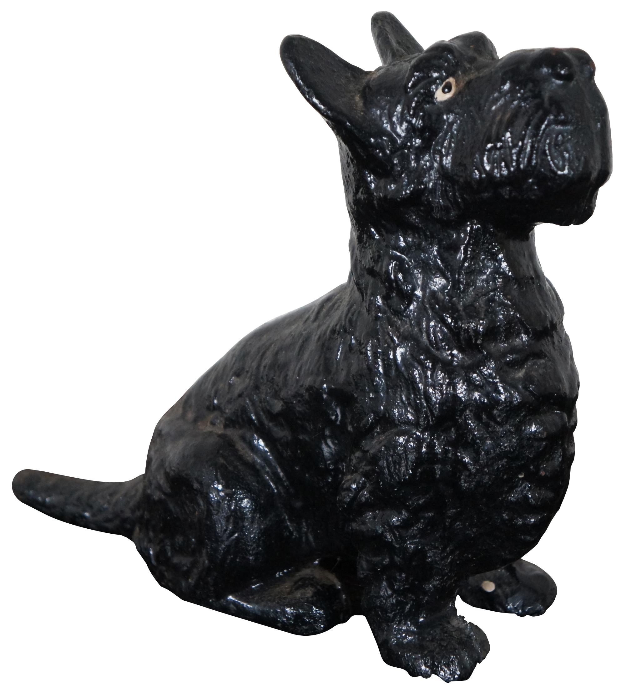 Antique cast iron door stop in the shape of a seated Scottish terrier.

In the casting process, metalworkers would carve out a wooden form or hammer the design out in metal. The form was then pressed into finely compacted sand, making an impression,