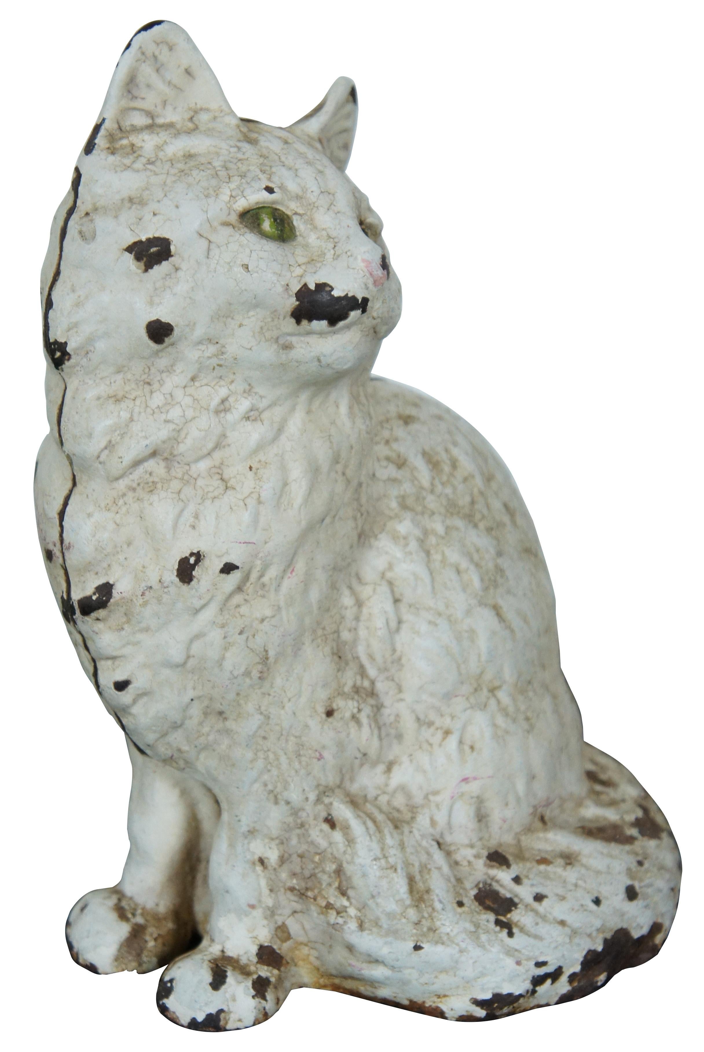 Antique cast iron doorstop in the shape of a seated, white, Persian cat with green eyes. Attributed to Hubley. #802. Measure: 9