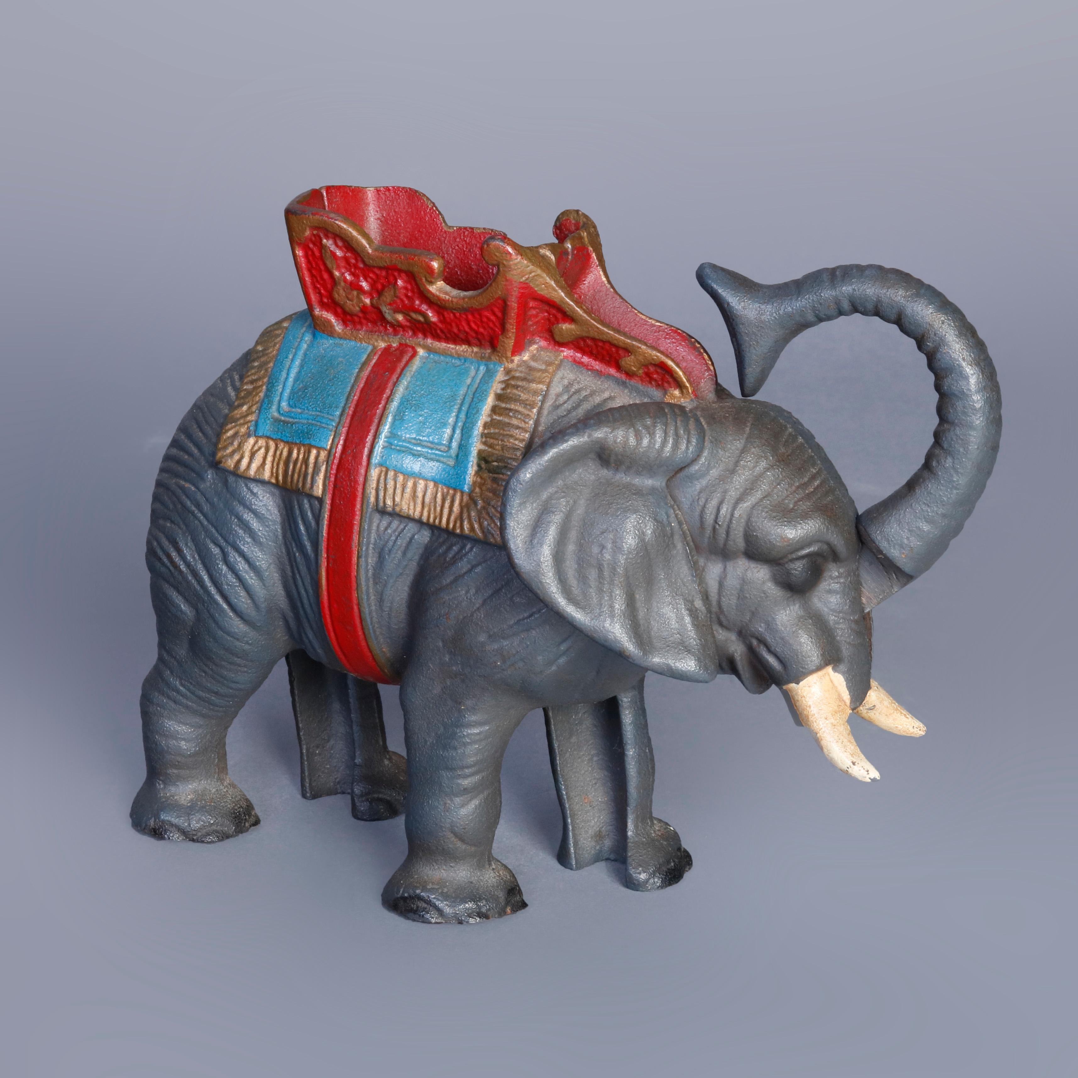 A Hubley School polychrome painted figural cast iron mechanical bank depicts a circus elephant with near mint paint and deposits coin held in trunk through opening in saddle, late 19th century or early 20th century. 

***DELIVERY NOTICE – Due to