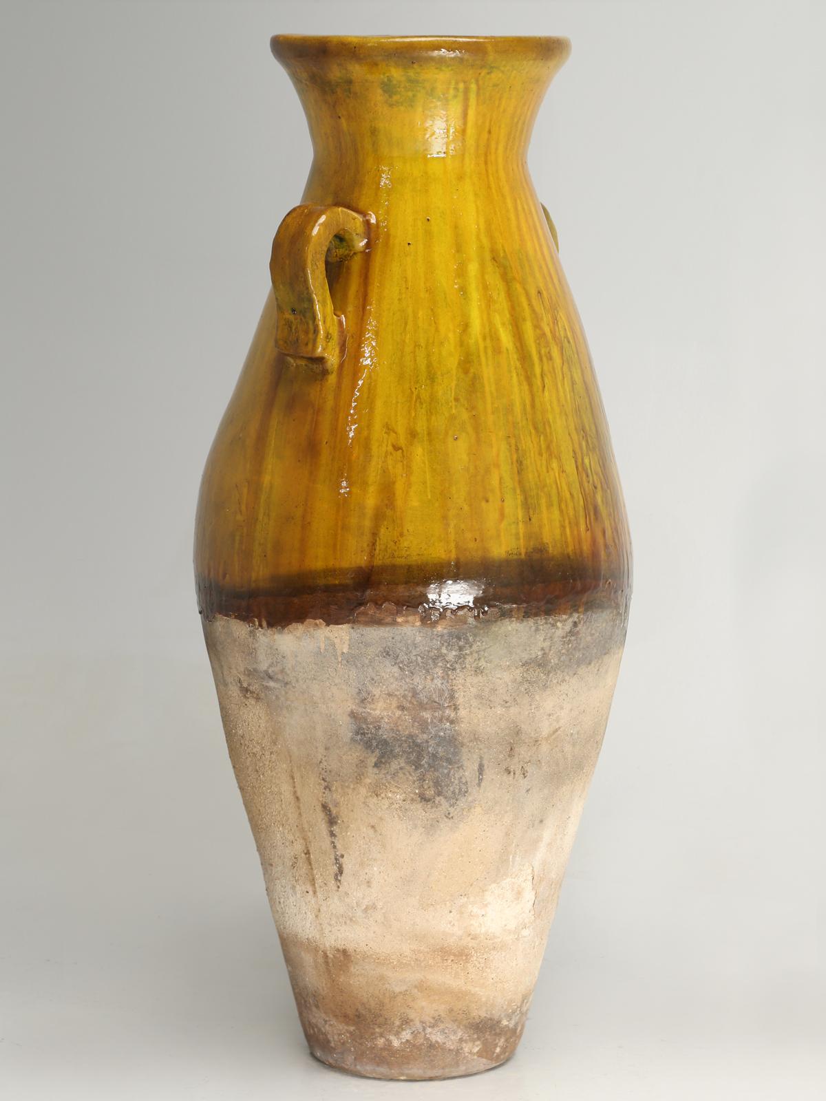 Commonly called an olive oil jar in the trade, but are actually an amphora, which is a type of container of a specific shape and dimension, beginning in the Neolithic Period, which ran from approximately 9000BC to 3500BC. Generally, Amphorae were