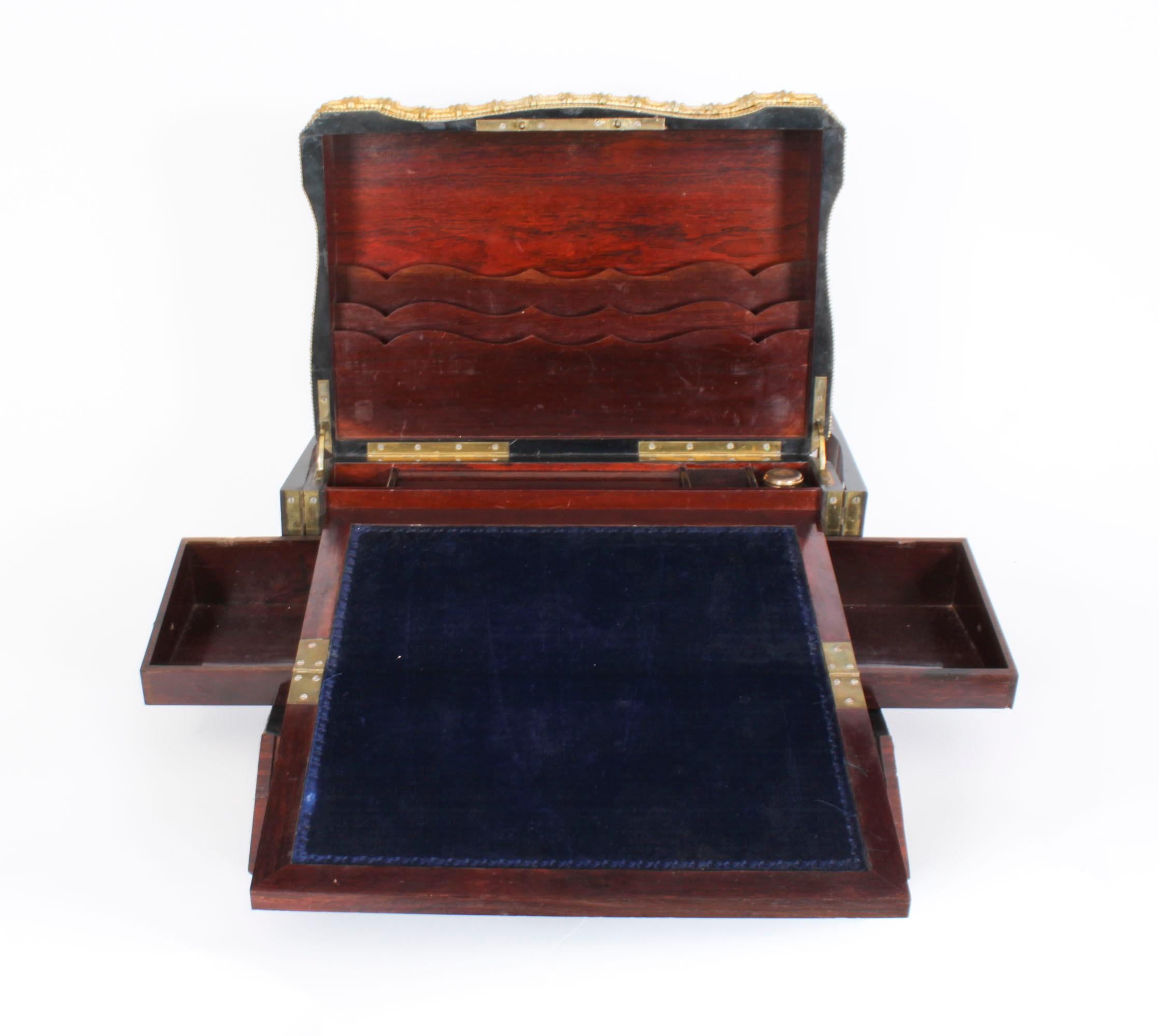 A French ormolu and porcelain cameo mounted amboyna writing box,  circa 1860 in date.

The rectangular casket features a lid with a central floral hand painted porcelain panel, crossbanding with ormolu decoration, opening to a fitted interior with a