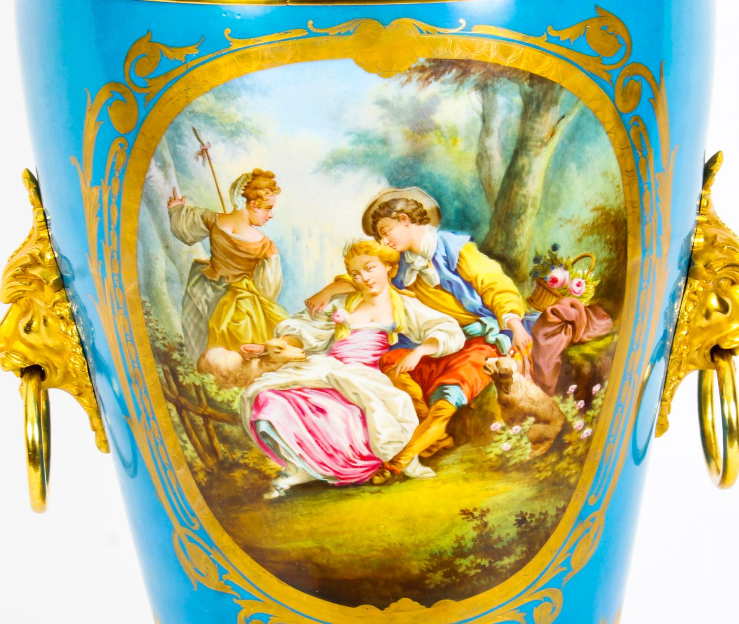 This is a wonderful antique large French ormolu mounted Sèvres Bleu Celeste porcelain jardinière, circa 1860 in date.
 
This striking jardinière features two delightful hand painted gilt bordered panel depicting lovers in a landscape on one side and