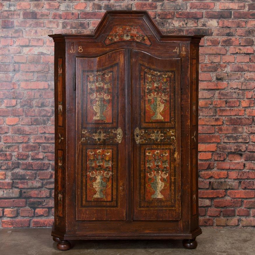 This exceptional armoire, in remarkable condition with the original paint intact, was created in 1841 most likely as a wedding gift. The colorful painted floral design was a traditional Hungarian folk-art style element during the 1800s. The casework