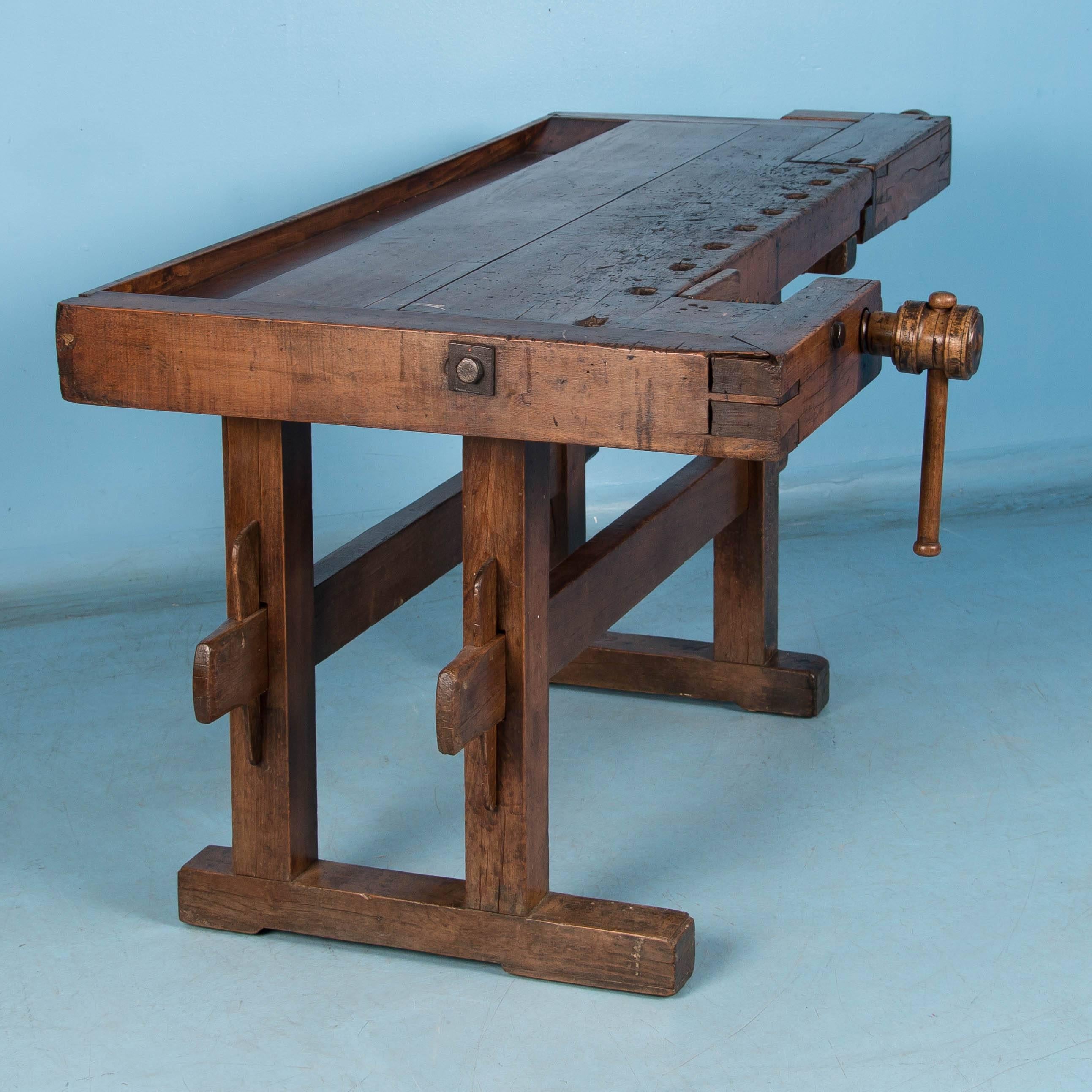 Beautiful antique Hungarian carpenters’ workbench, bearing an incredible patina after years of traditional use. It has two vices with wood handle and a recessed tray where the carpenter would lay his tools. The traditional trestle base allowed it to