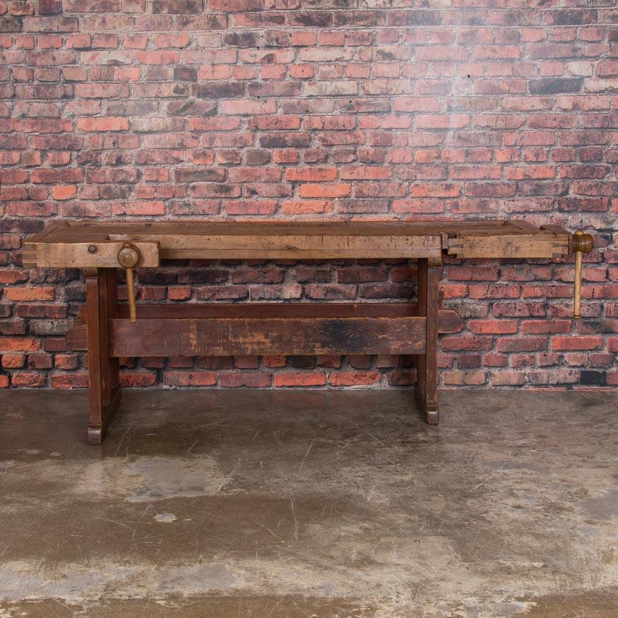 Beautiful antique Hungarian carpenters’ workbench, bearing an incredible patina after years of traditional use. It has two vices with wood handle and a recessed tray where the carpenter would lay his tools. The traditional trestle base allowed it to