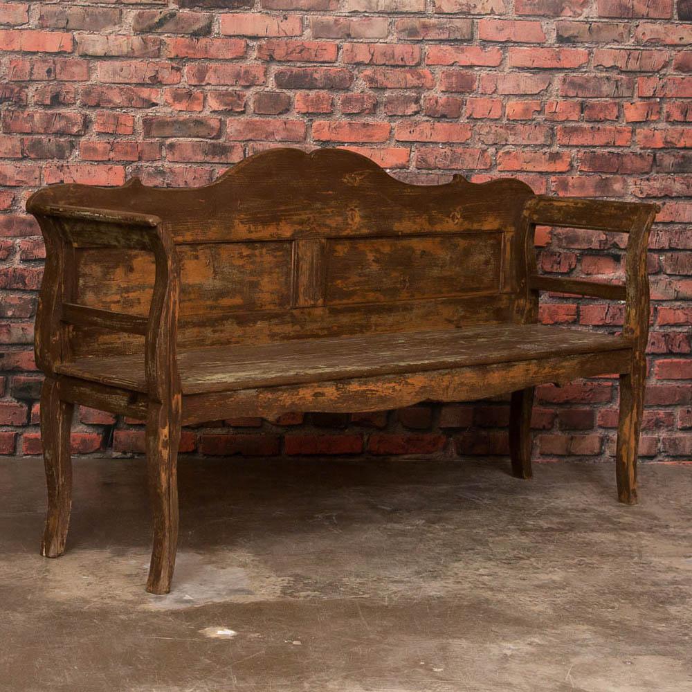 The pale green paint revealed on this country bench creates an inviting appeal to sit and relax. This style of bench was found in country farm houses throughout Europe in the 1800s. Layers of paint have been worn off through years of use, including