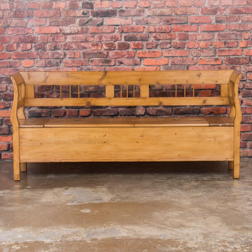 The beauty of this bench is in the warm natural pine and simple European country craftsmanship. This style of bench was a common element in homes throughout Europe in the 1800s. The bench seat is hinged, and when open reveals storage space below.