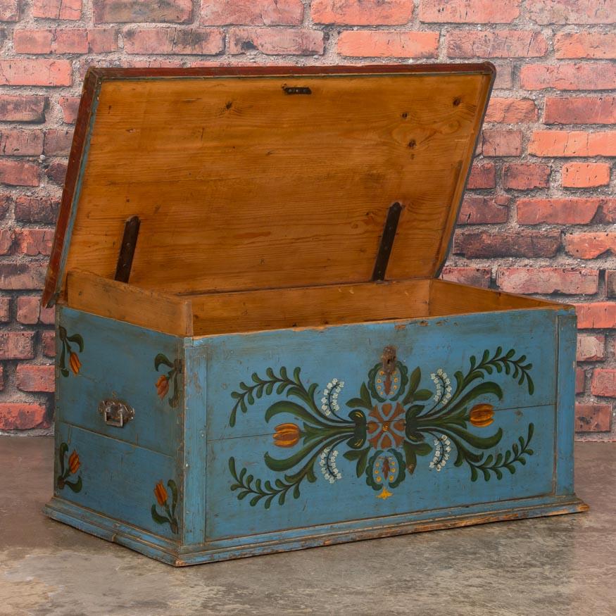 Utterly charming, this trunk is a special find due to its petite size and superb original paint which has been well preserved over 130 years of use. The bright blue background and delightful floral details are wonderful examples of the traditional