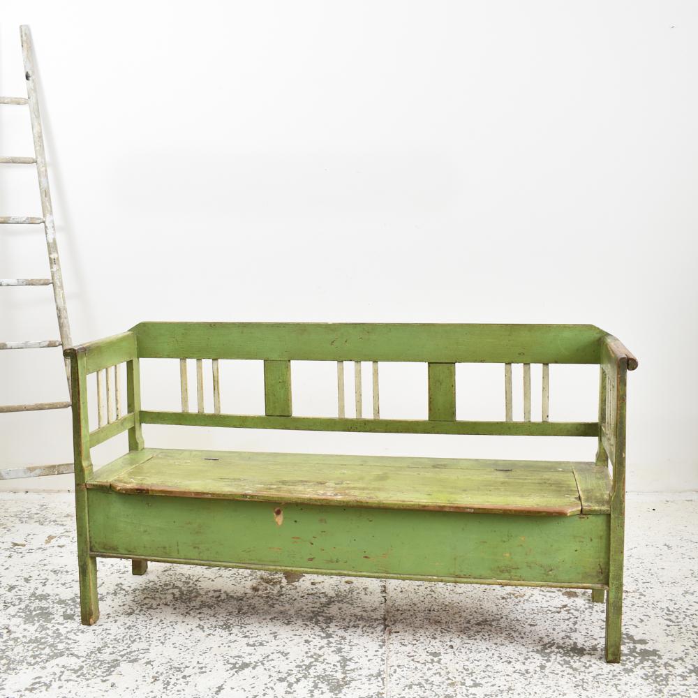 Pale green antique Hungarian settle bench.

An original settle bench salvaged from an Hungarian farmhouse. The bench has been left in its original condition, made from pine and painted in a light green colour. The bench has some lovely original