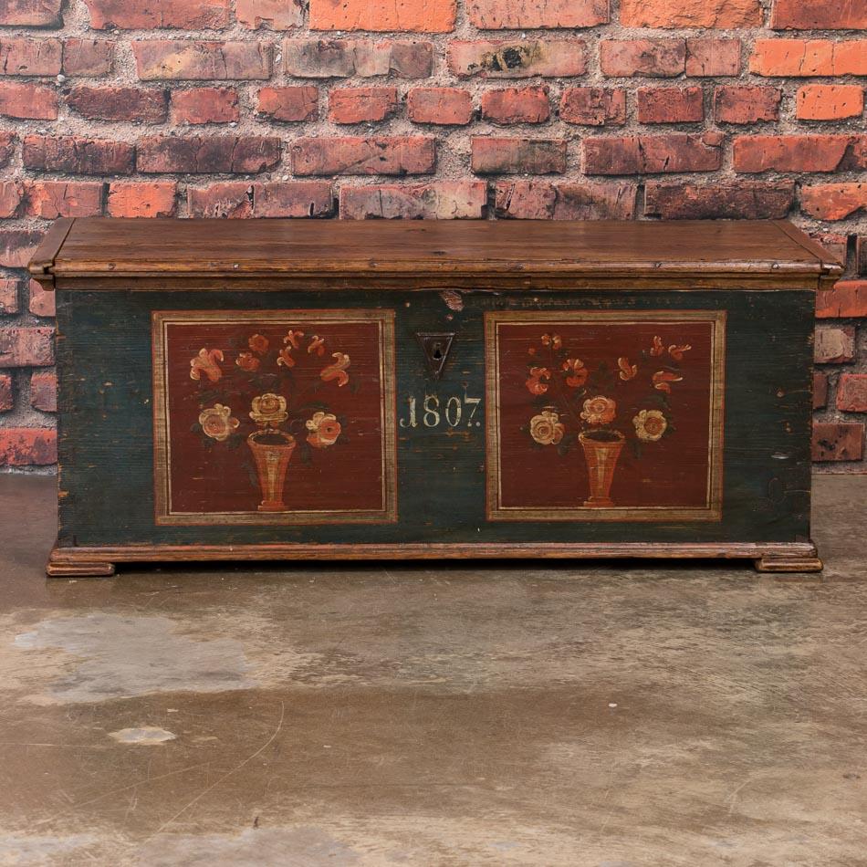 Utterly charming, this trunk is a special find due to its superb original paint which has been well preserved over years of use. The deep blue background and delightful floral details are wonderful examples of the traditional painting style in rural