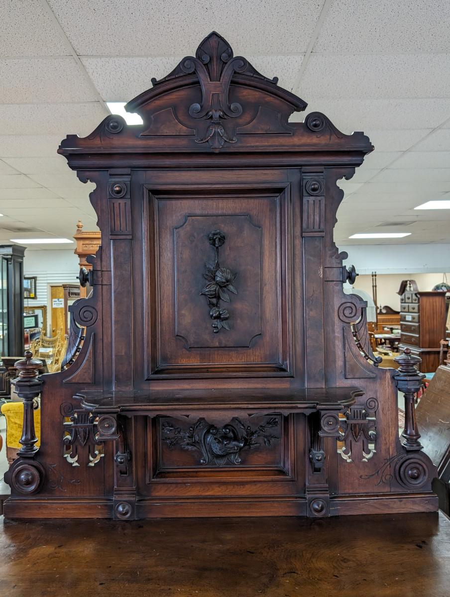 Hunt Sideboard, Circa 1850’s, Solid Walnut, Carved Crest, Back Splash has carved edges, Spindle accent on either side, Wild Boar head carving under top shelf, Two drawers over triple-door cabinet, Bottom case has 2 shelves, Doors have Burled reliefs.