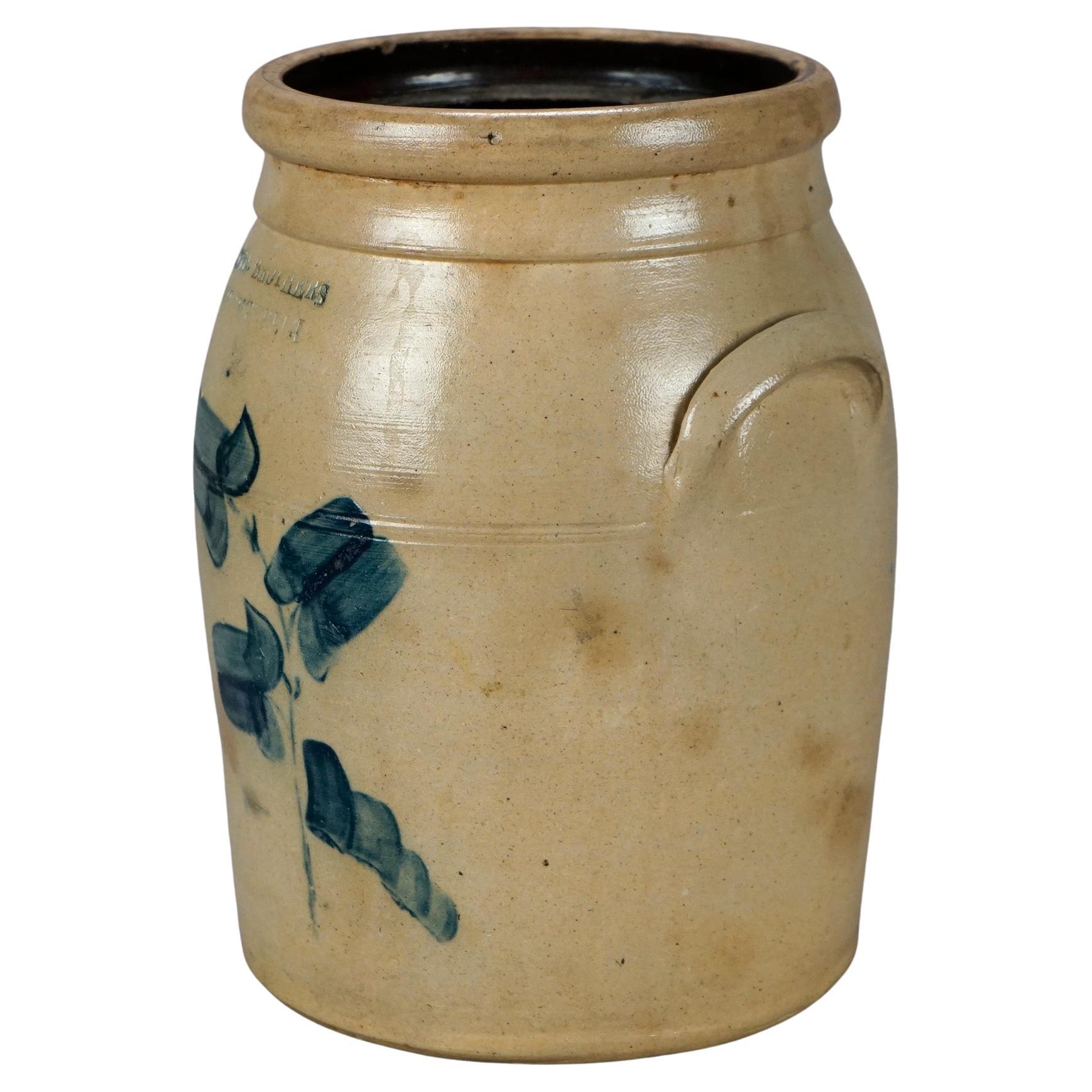 An antique crock by Brown Brothers of Huntington, Long Island, New York offers salt glazed stoneware construction with double handles and blue decorated stylized flower, incised with maker as photographed, 19th century

Measures- 12''H x 8.5''W x