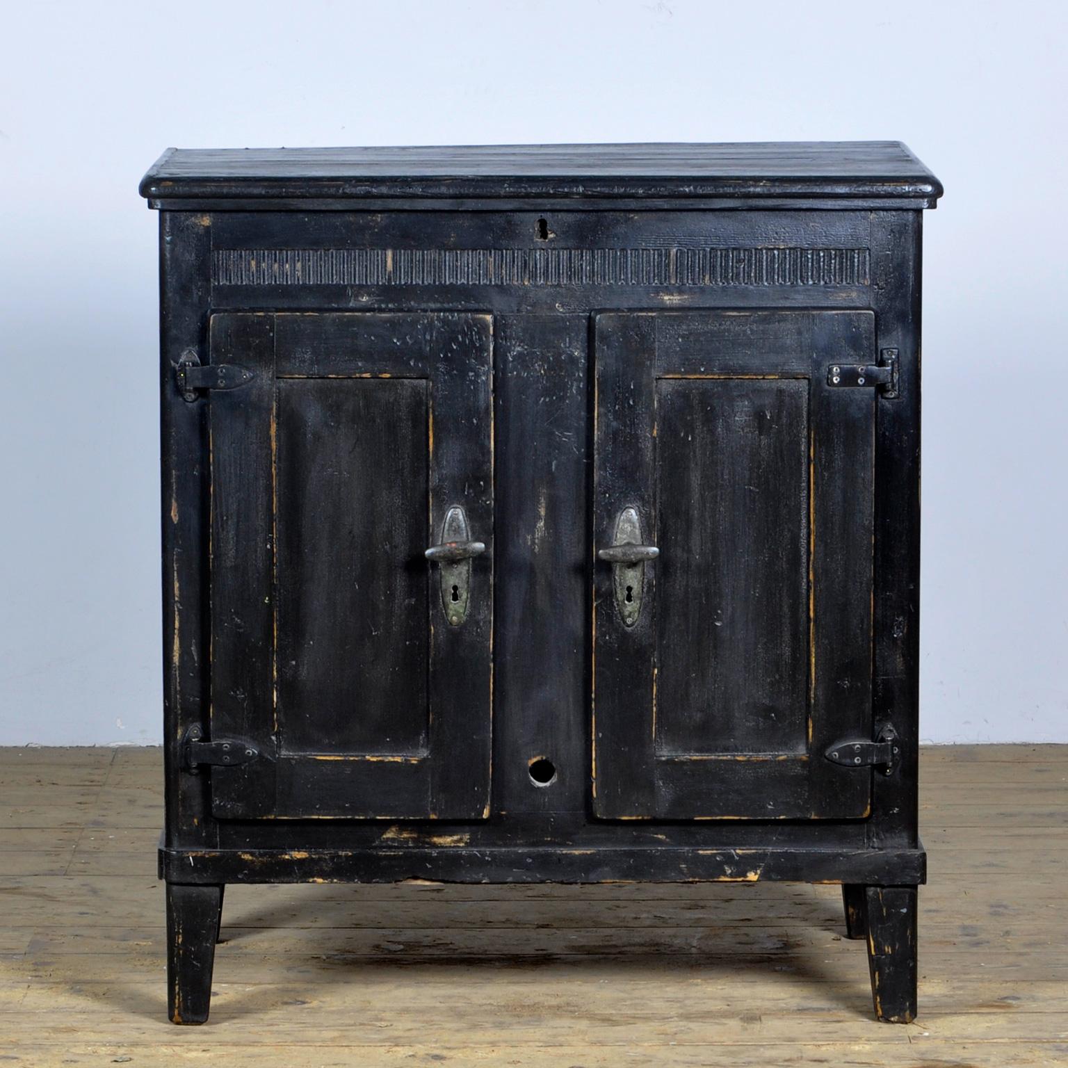 A rare precursor to our modern refrigerator and freezer, this rustic pine cabinet has a zinc-lined interior and a central compartment, accessed by lifting the lid, where the ice was kept.  It has its original hinges and locks. The cabinet comes from