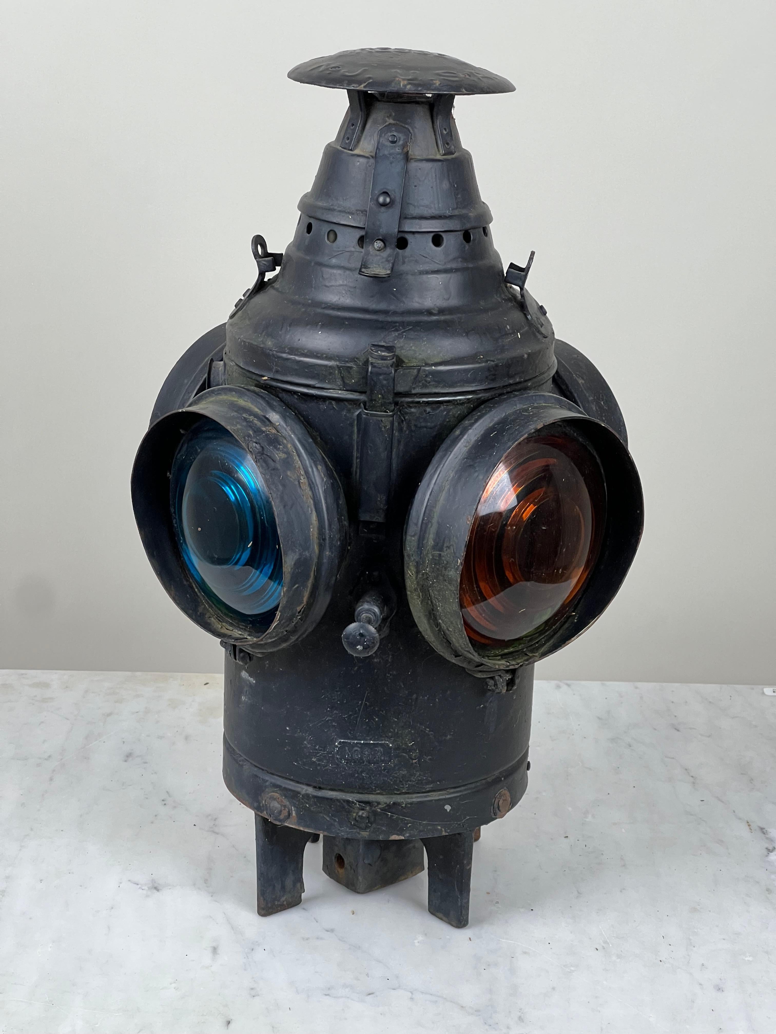 This antique railroad lantern is a striking survivor from the golden age of American rail travel, made by the well-known Dressel Railway Lamp & Signal Co. of Arlington, New Jersey. Produced for the Illinois Central Railroad, the lantern features its