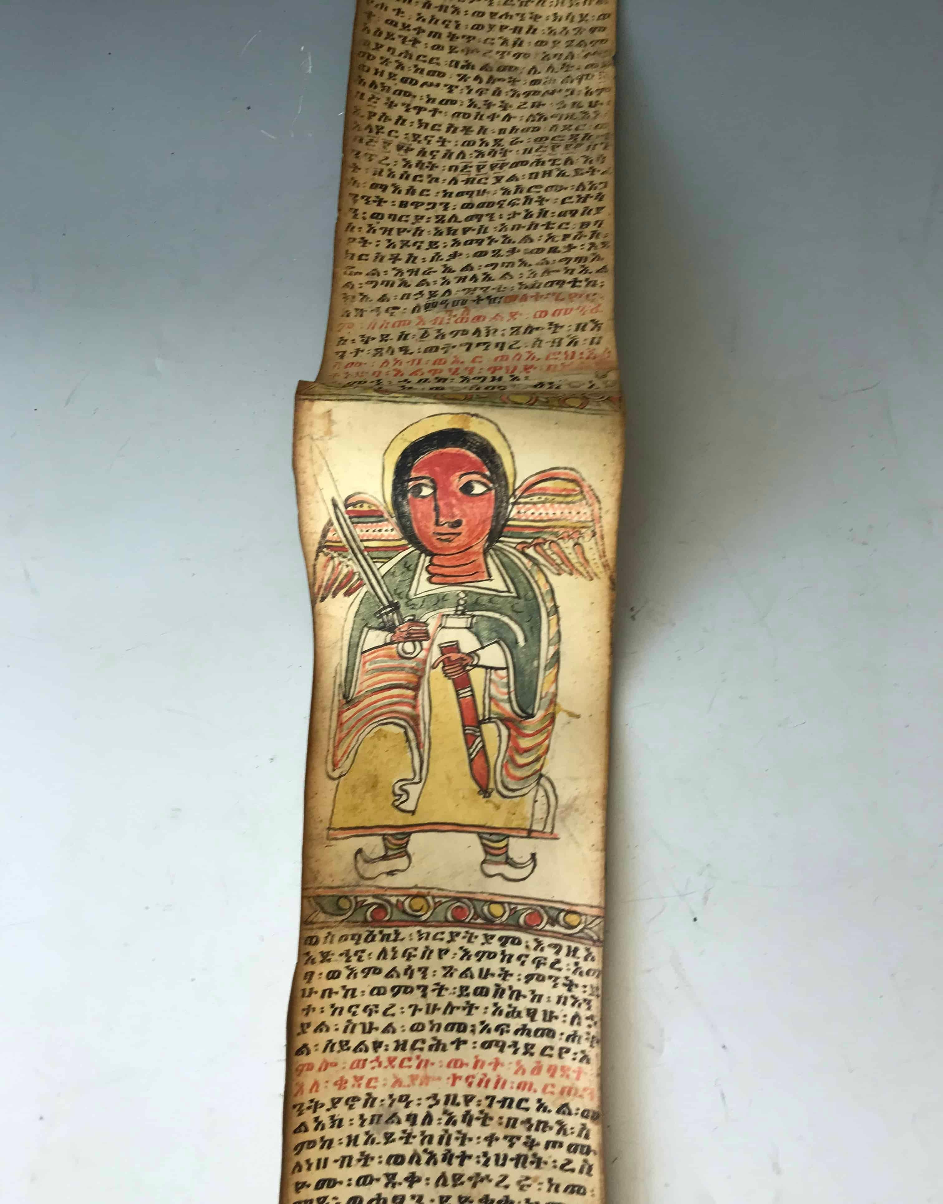 A antique illuminated Ethiopian coptic magic/healing scroll.

A traditional Coptic Christian scroll  painted on Animal sections of skin vellum sewn together in sections, the text is written in a ancient language called Ge`az  this scroll is