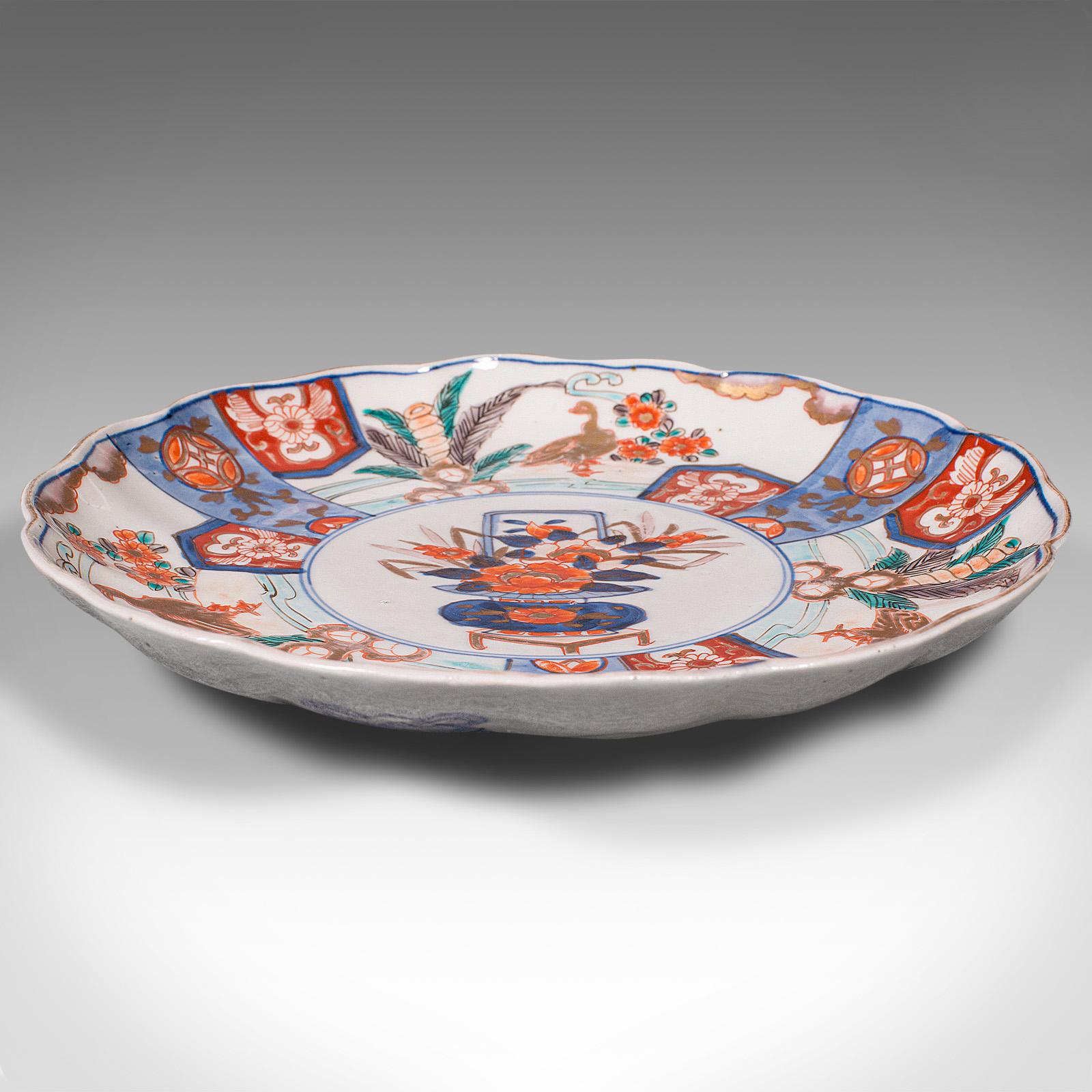This is an antique Imari plate. A Japanese hand-painted ceramic serving dish, dating to the late Victorian period, circa 1900.

Charming example of Imari taste with appealing colour
Displays a desirable aged patina and in good order
White ground
