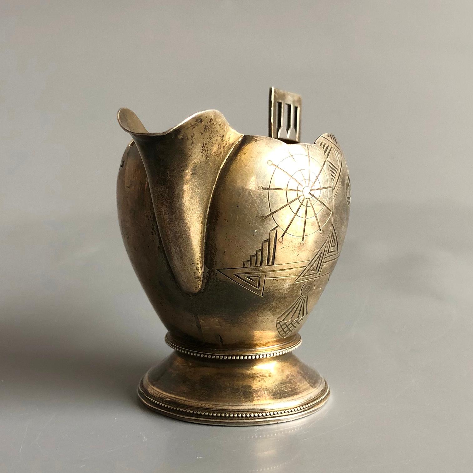 Antique Imperial Russian 84 engraved silver creamer.
.875 (84 Zolotniki) silver, Silver gilt - Kuzmichev Antip Ivanovich ( 1856– 1917 )
Marked accordingly on several places with Moscow 84 silver and “A. K” for Antip Kuzmichev. 
Very good