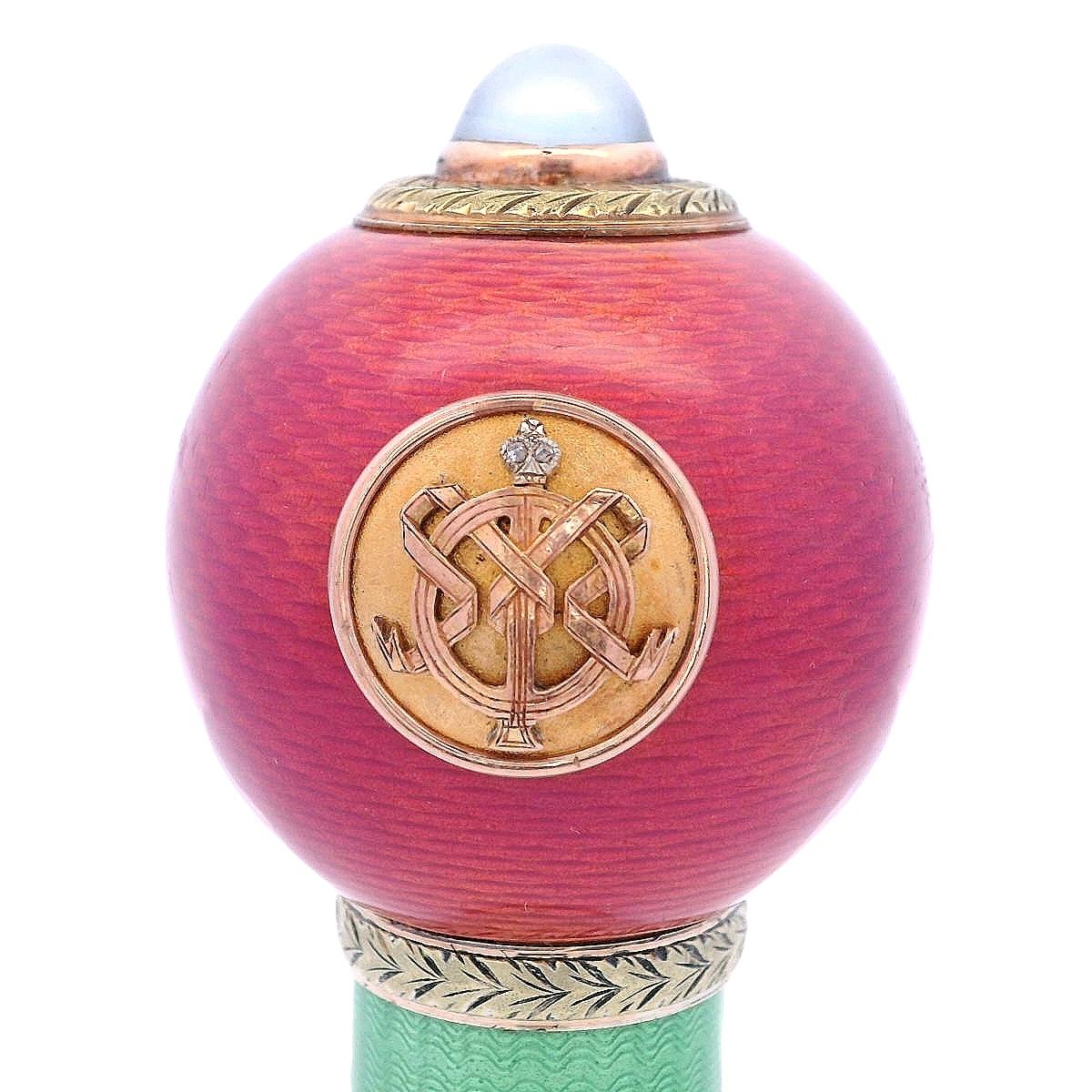 This exquisite Antique Imperial Fabergé Parasol Handle showcases a stunning blend of artistry and craftsmanship. Made of rose gold, the handle is adorned with intricate guilloché enamel, which features a delicate pattern that catches the light