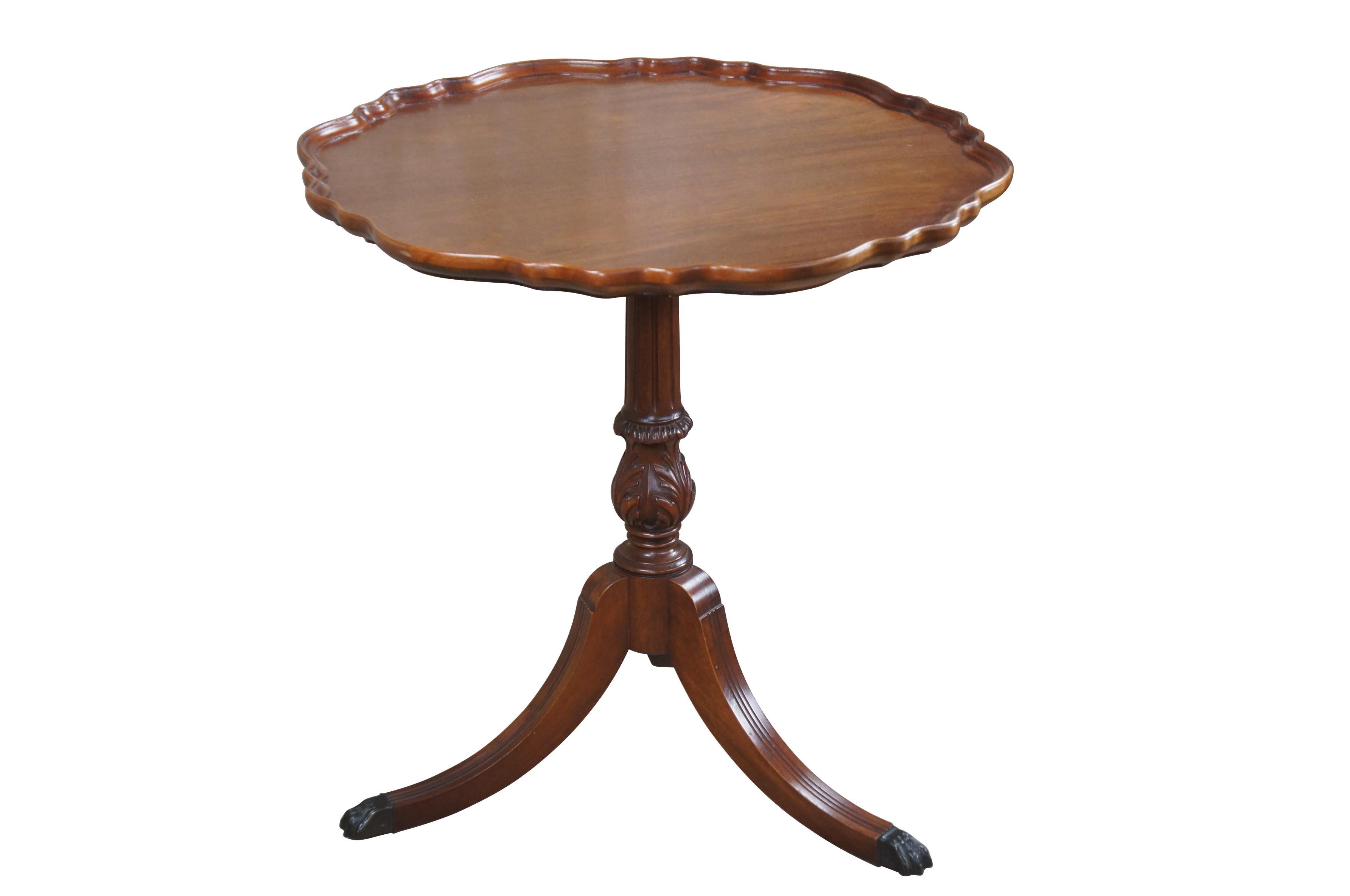 1940s Duncan Phyfe style pie crust table by Imperial Furniture of Grand Rapids. Made from mahogany with an inset scalloped top over a turned and fluted pedestal leading to downswept Duncan Phyfe legs with metal capped paw feet. Marked Imperial Grand