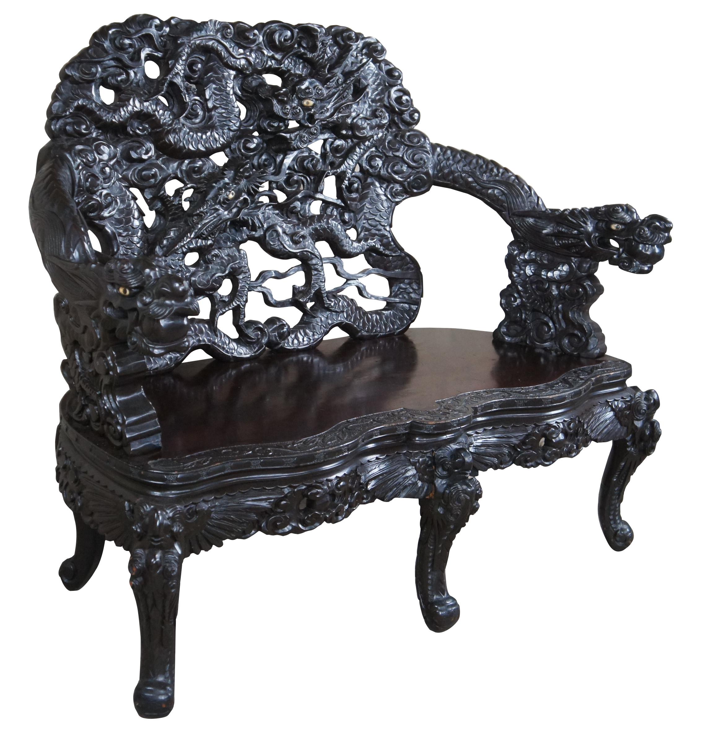A fine and impressive Imperial Japanese Meiji Period Ebonized Rosewood Dragon Bench. Features high relief carving throughout. The arched and pierced back consists of 4 dragons. In the center are two large and intricate snarling three toed dragons.