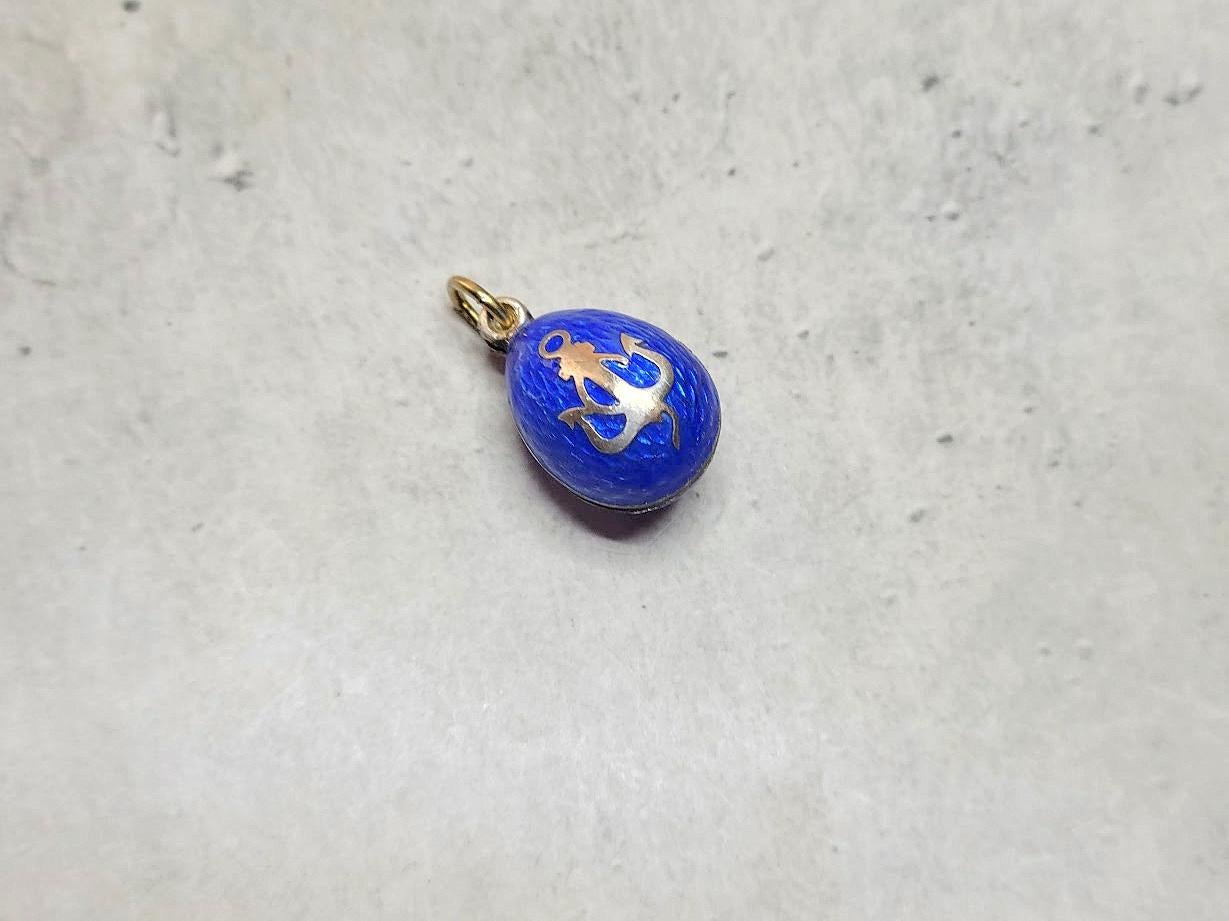 A Fabergé workmaster Anders Johan Nevalainen silver egg pendant, guilloche blue enameled and adorned with a ship's wheel and anchor, was made in St. Petersburg, Russian Empire, in the late 19th century/early 20th century.

Anders Juhaninpoika