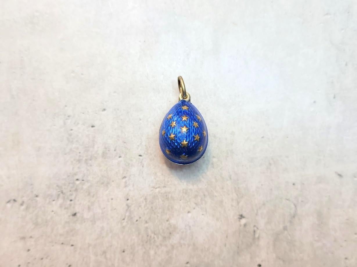 We present to you an exquisite silver-gilded egg pendant. This silver gilded egg is covered in stunning dark blue guilloche enamel and adorned with many tiny golden stars.

This pendant was crafted in Imperial Russia, as confirmed by the hallmarks