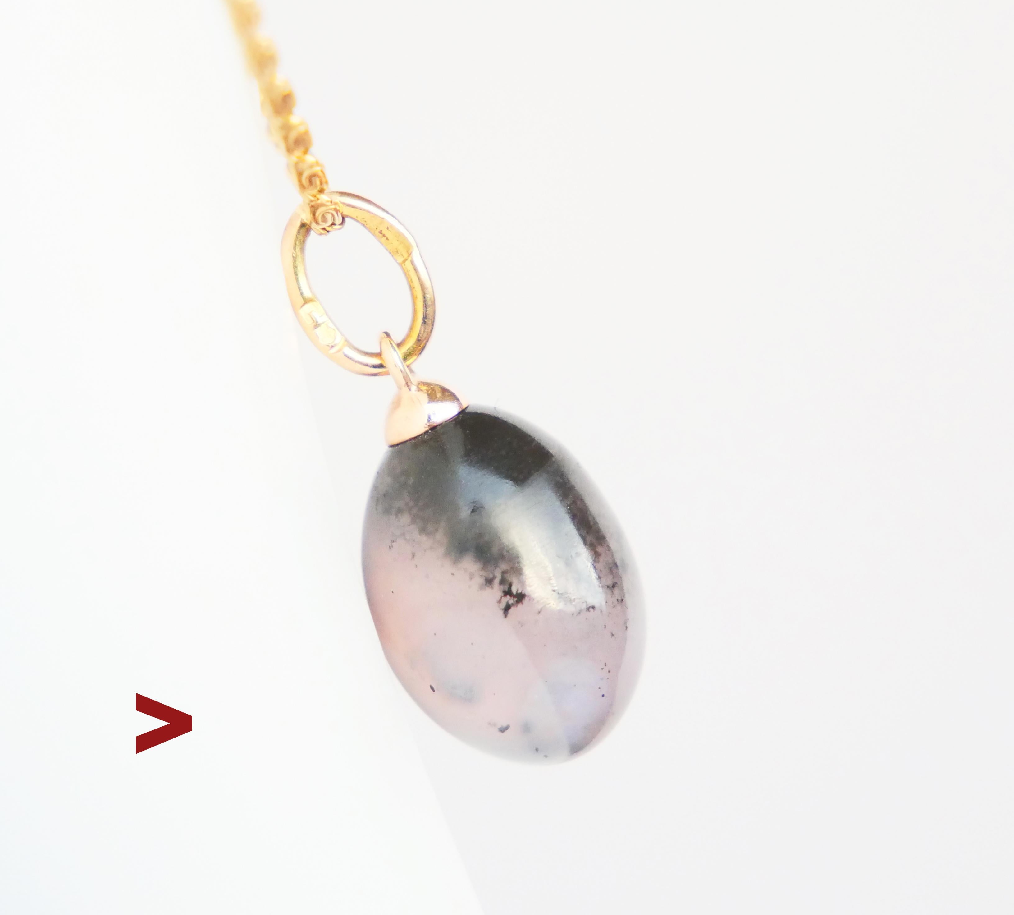 Antique miniature Passover Egg pendant made in Imperial Russia between the years 1898 - 1908.

Body in solid Russian Chalcedony from famed deposits in the Ural Mountains mounted on 14K Gold hanger. The colors of this stone are a fuzzy mix of Grey,