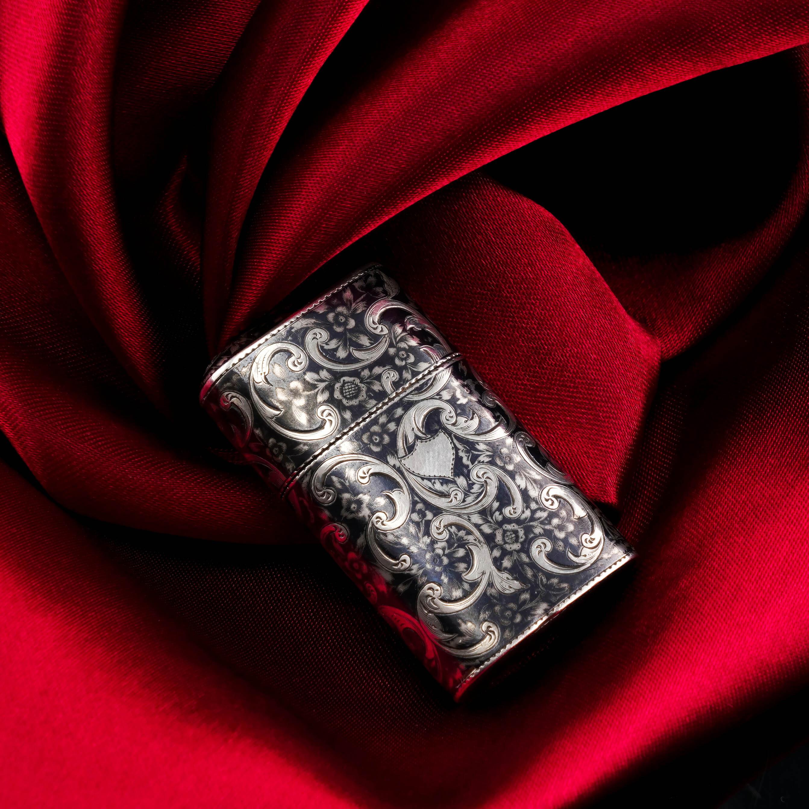 We are delighted to offer this intricate and distinguished antique Imperial Russian vesta case. 
 
The case is beautifully decorated with contrasting hand-engraved silver and niello with the entire exterior featuring floral and foliate scrolls and