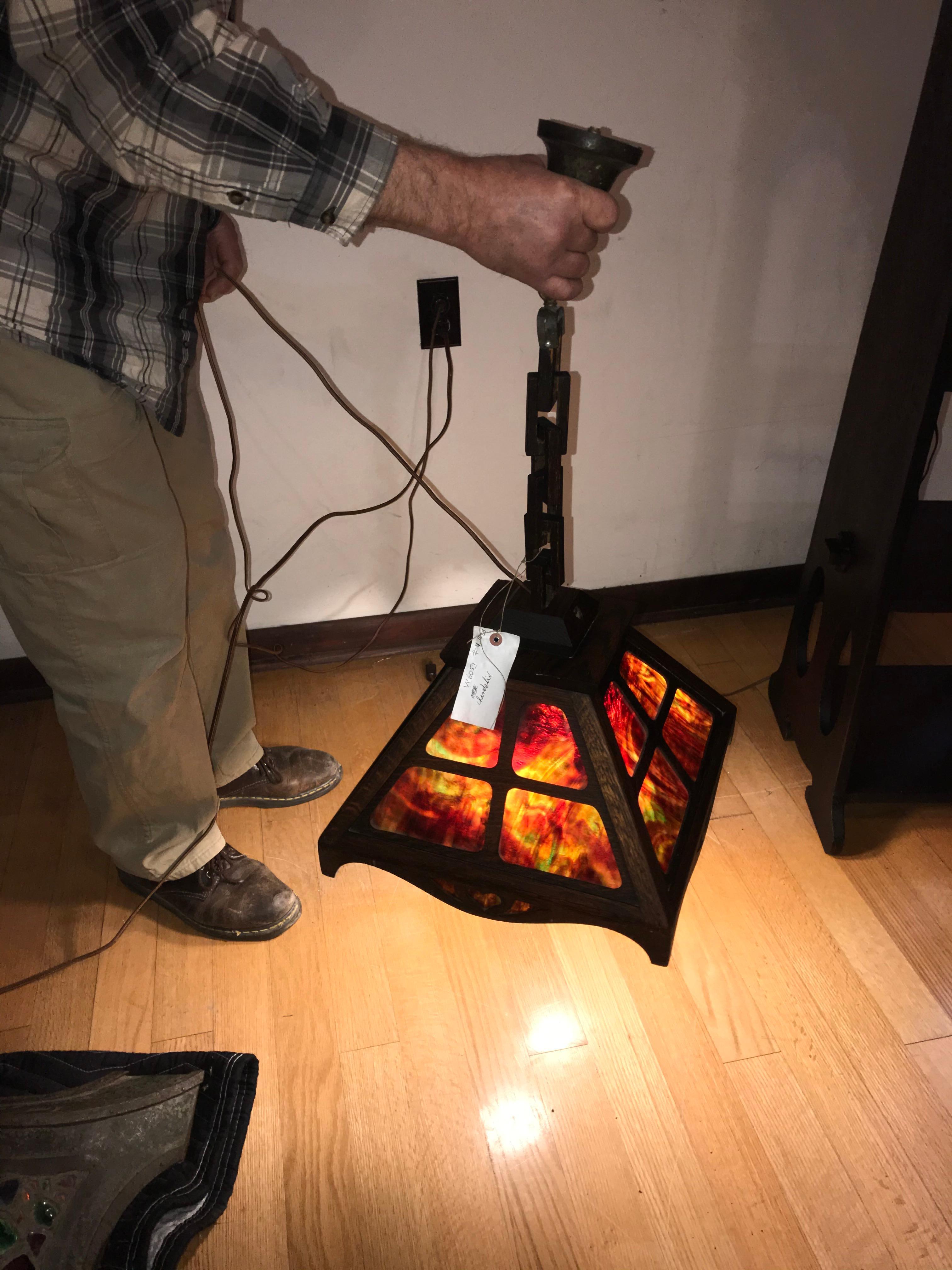 This is an antique important stained glass chandelier made by J. Brown in Indiana.  The glass is in perfect shape with no nicks or damage.  It features a wooden chain which is one of the things Mr. Brown was known for.  This item is ready for use in