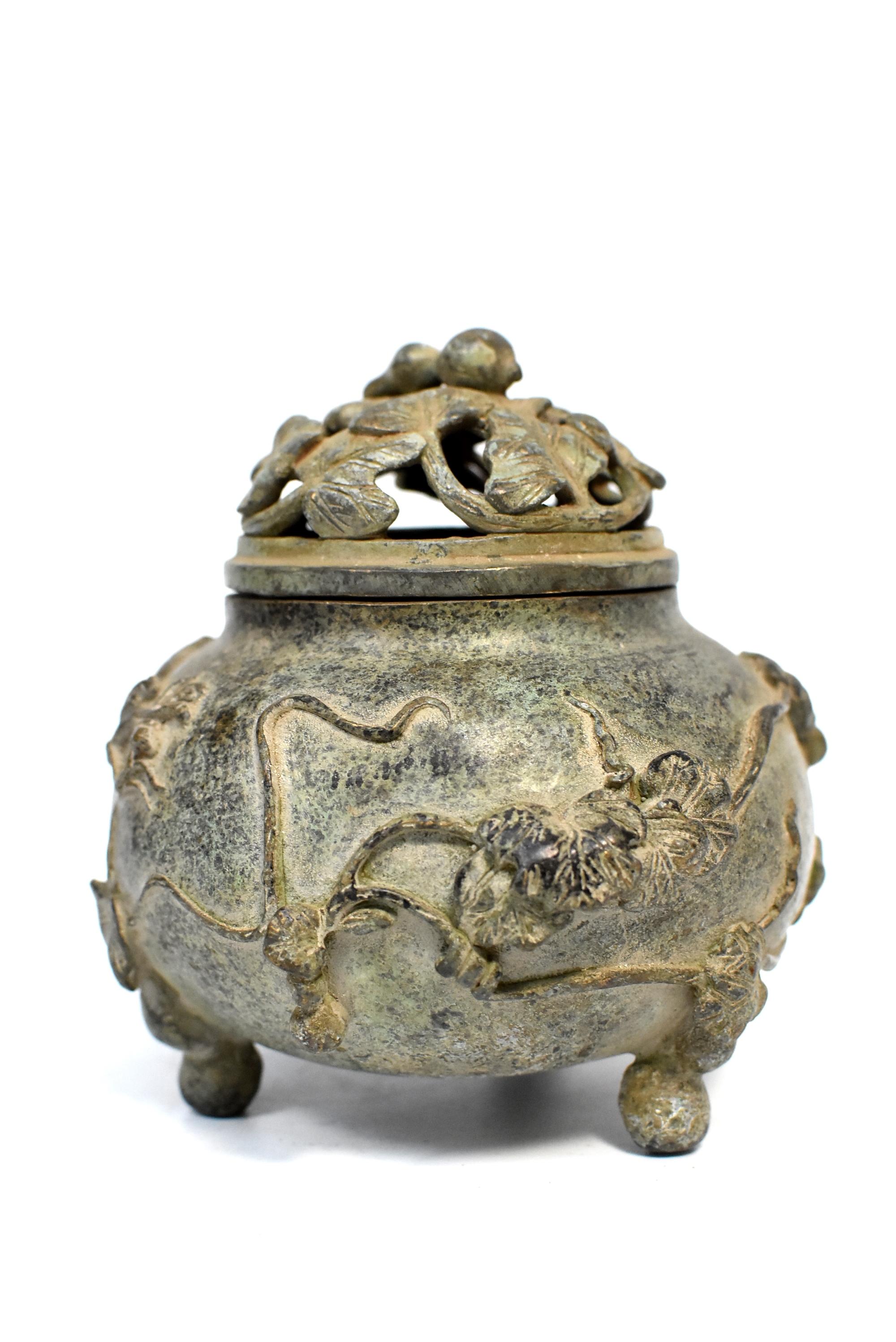 A beautiful Chinese antique bronze incense burner featuring the elegant gourd form. The vine is found on the lid and the body of the burner. A gourd is used as a finial. 3-foot design makes the burner stable. Signed and stamped.