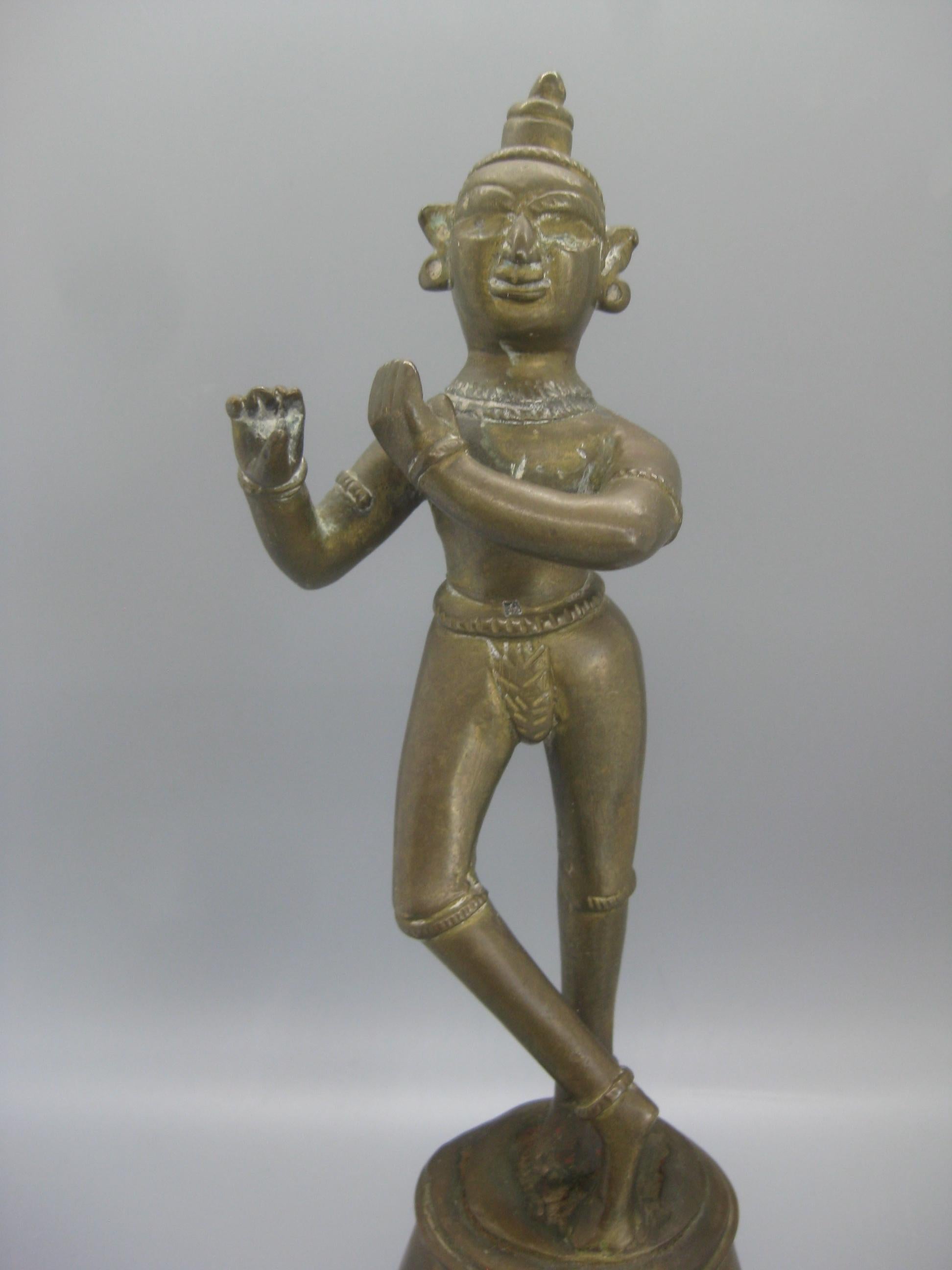 Very unique antique India Hindu Lord Krishna standing statue sculpture. Made of brass and has a wonderful patina. This is a very old piece. In very nice original condition with no damage. Measures: approx. 9 3/4