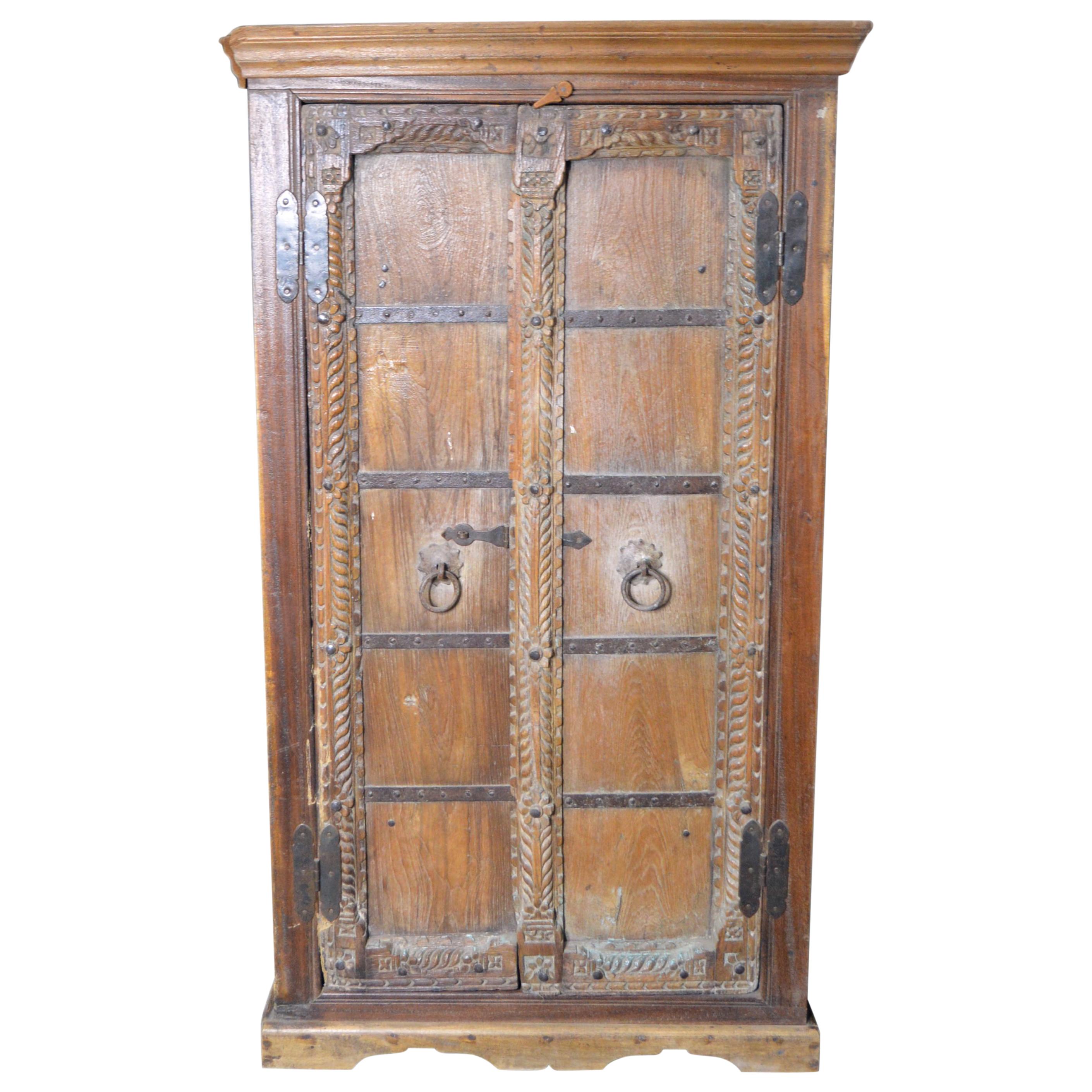 Antique Indian 19th Century Armoire with Metal Braces and Hand-Carved Decor