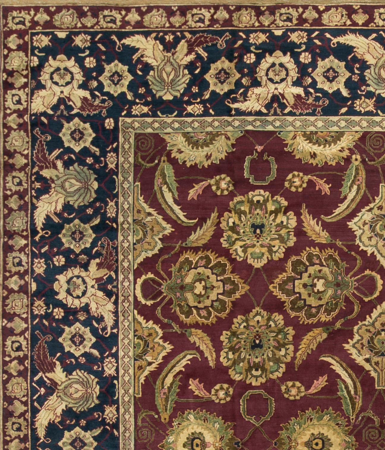 his antique Indian Agra rug, dating back to circa 1890, showcases a distinctive and finely crafted design. Agra rugs are known for their grandeur and often feature bold floral patterns and intricate details. The central field of this rug likely