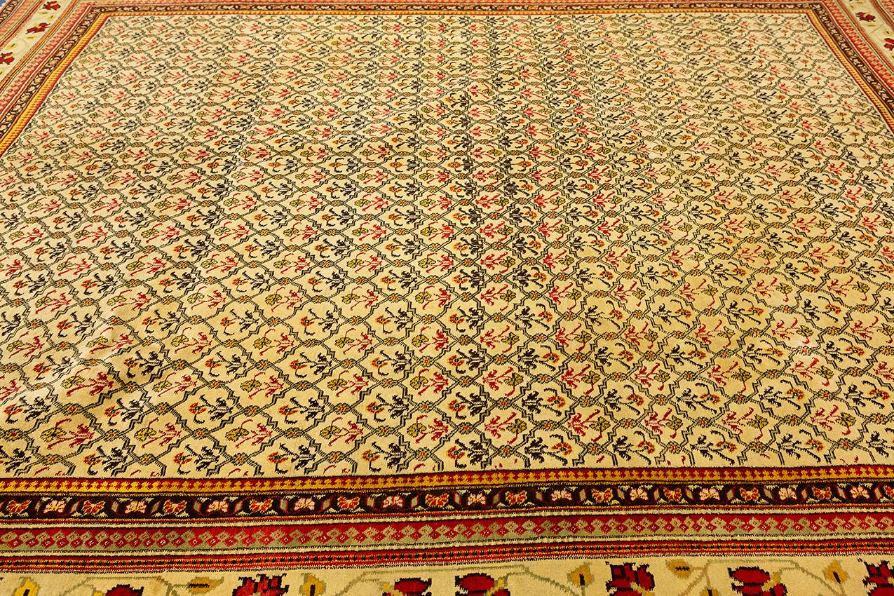 Hand-knotted in the 19th century, this antique Indian rug called Agra has wool pile over cotton warp and weft, and measures 10' 9? × 9' 6? (330 × 290 cm). Between 1500 and 1700, there were intense cultural exchanges between the Safavid Empire and