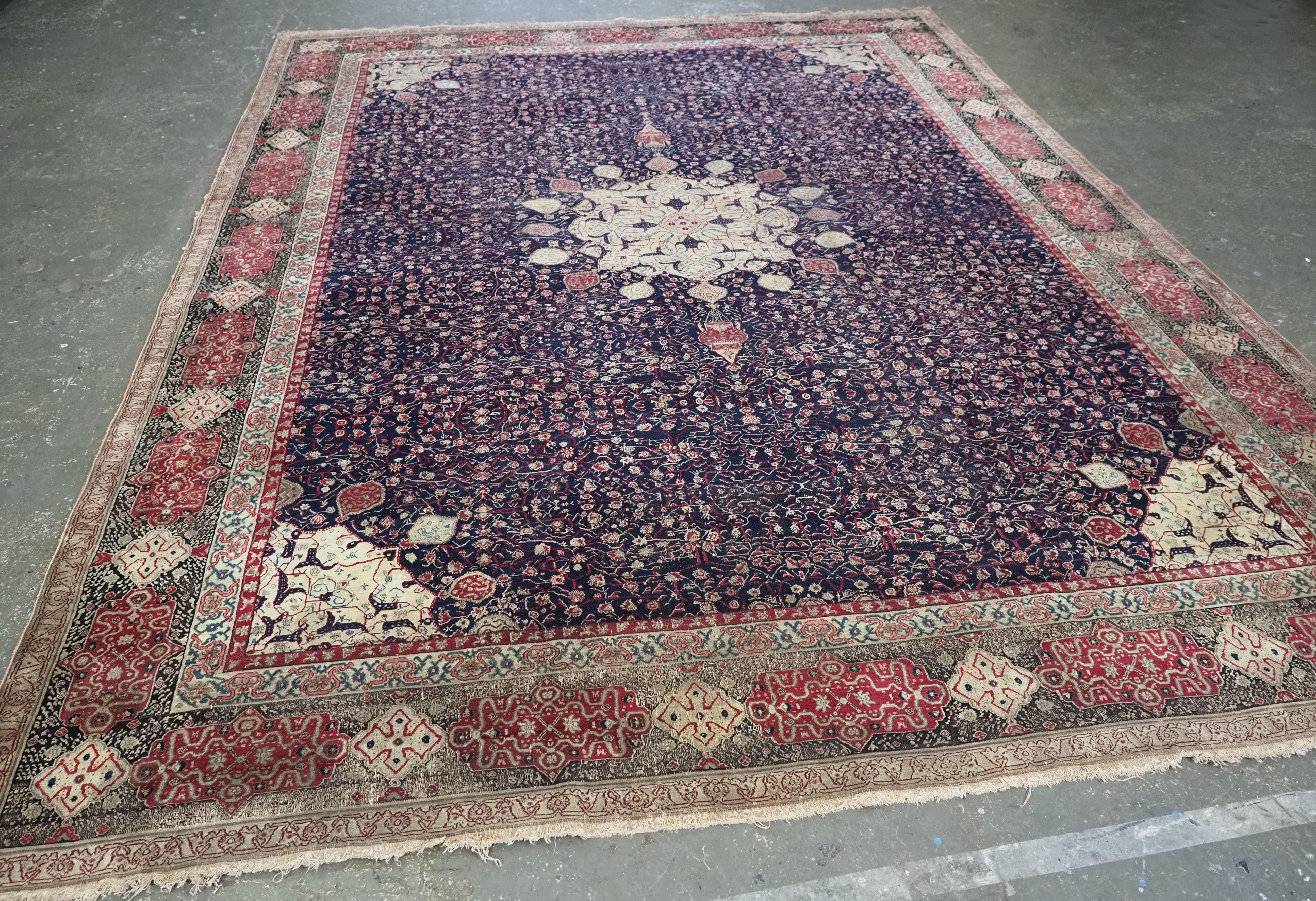Size: 11ft 8in x 8ft 11in (355 x 273cm).

Antique Indian Agra carpet of 'Ardabil' design.

Circa 1880.

A superb and very finely woven Agra carpet, with the 16 lobed ivory coloured central circular medallion, with lanterns hanging at each end. The