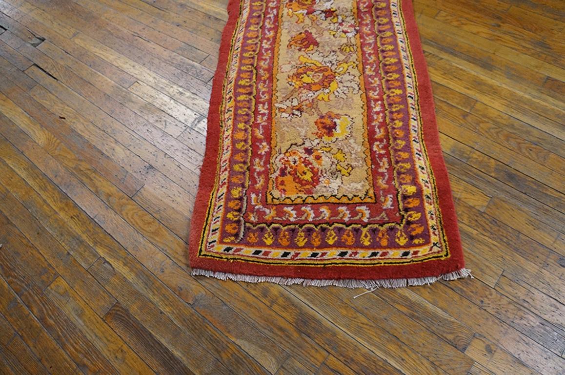 If a pattern works for a border, it is equally suited for a runner. Here a complex, ragged palmette Meander is set on a khaki field. Antique narrow runner (kenare) detailed in goldenrod, wine red and light rust-salmon. Good condition. Measures: 2'5