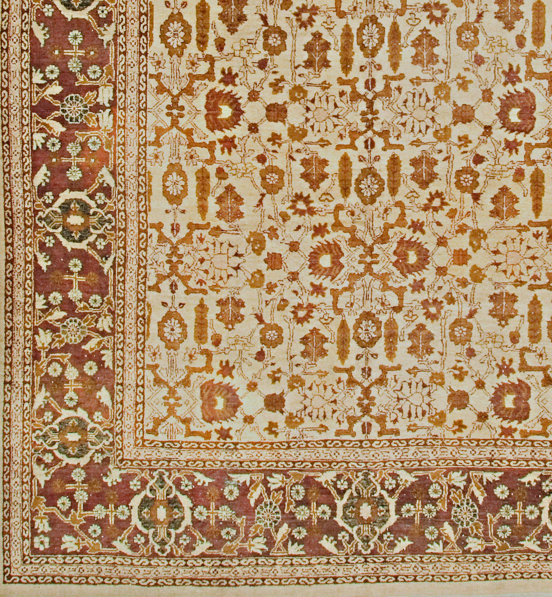 Antique Indian Agra rug, circa 1900. The pattern is endless in this decorative antique Agra carpet. Appearing to pass beneath the border the array of angular vine segments sectional palmettes stylized cypress trees and various natural elements