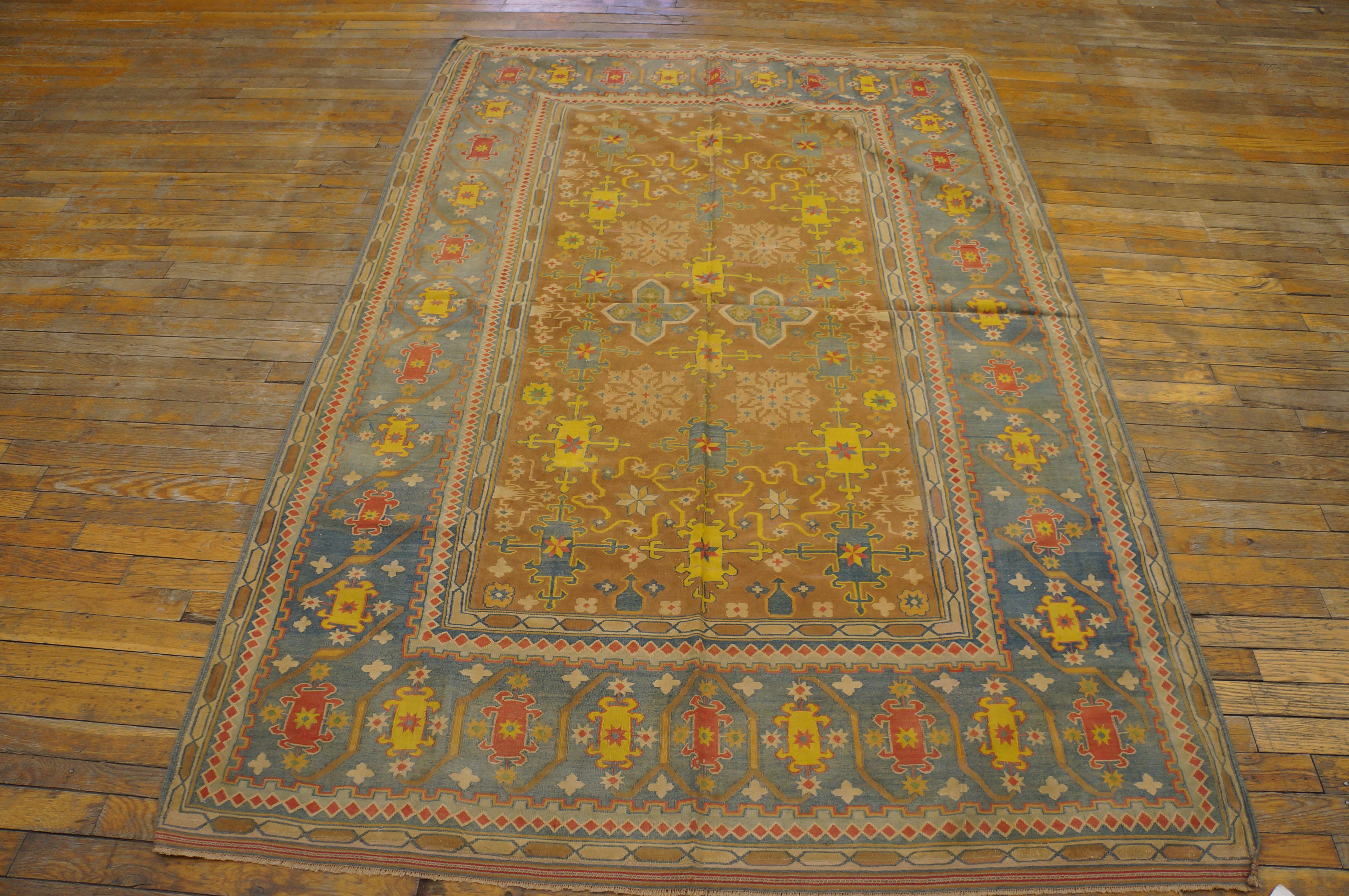 The soft camel-tone ground of this antique all cotton flat-woven scatter presents a pinwheel, octogramme and cruciform allover mixed pattern detailed in yellow, light blue and light green. The main border attractively abrashes from pale blue to
