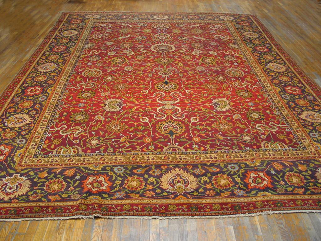 With an impeccable classical design ancestry, this red-rust ground northern Indian antique city carpet shows a two layer round arabesque pattern with in-and-out palmettes and cloud bands, accented with tiny birds. The navy border shows reversing