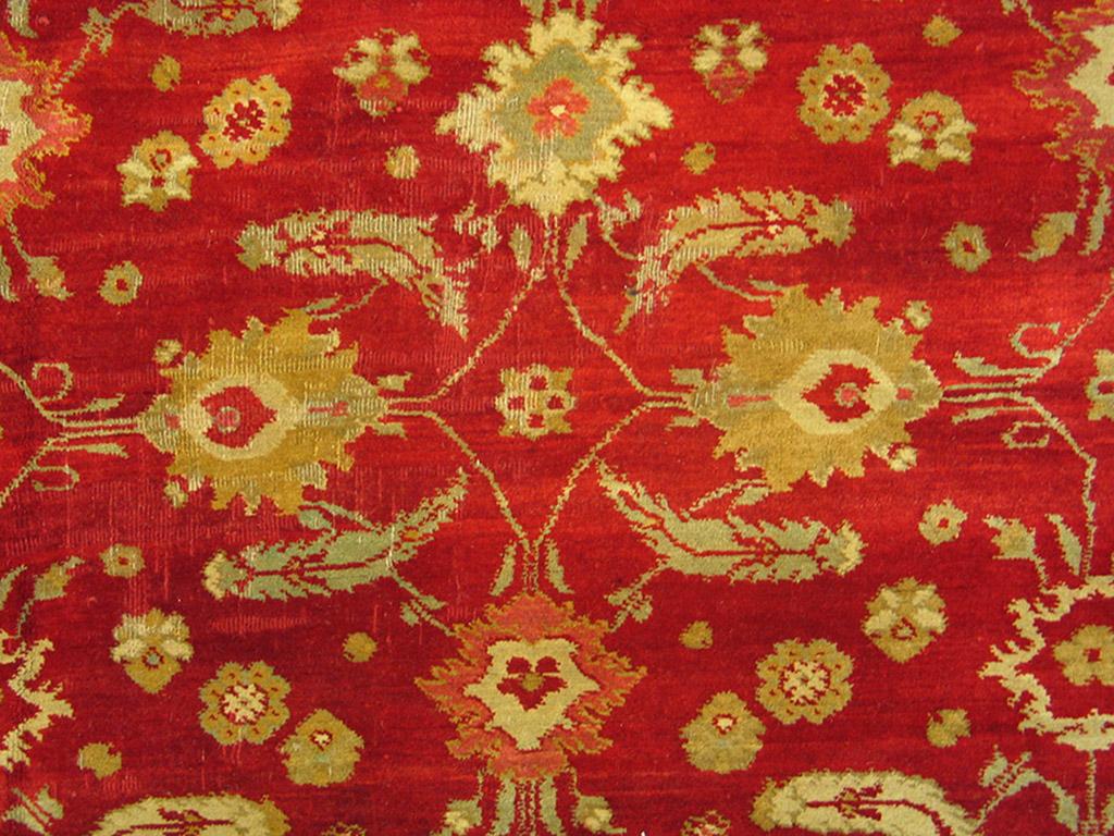 This antique northern Indian urban carpet is really red and displays a perfectly balanced all-over Herati pattern of ‘fish’ leaves, concave diamonds and palmettes, set within a pale green border with tiny leaves. Good condition. Elegant, yet a