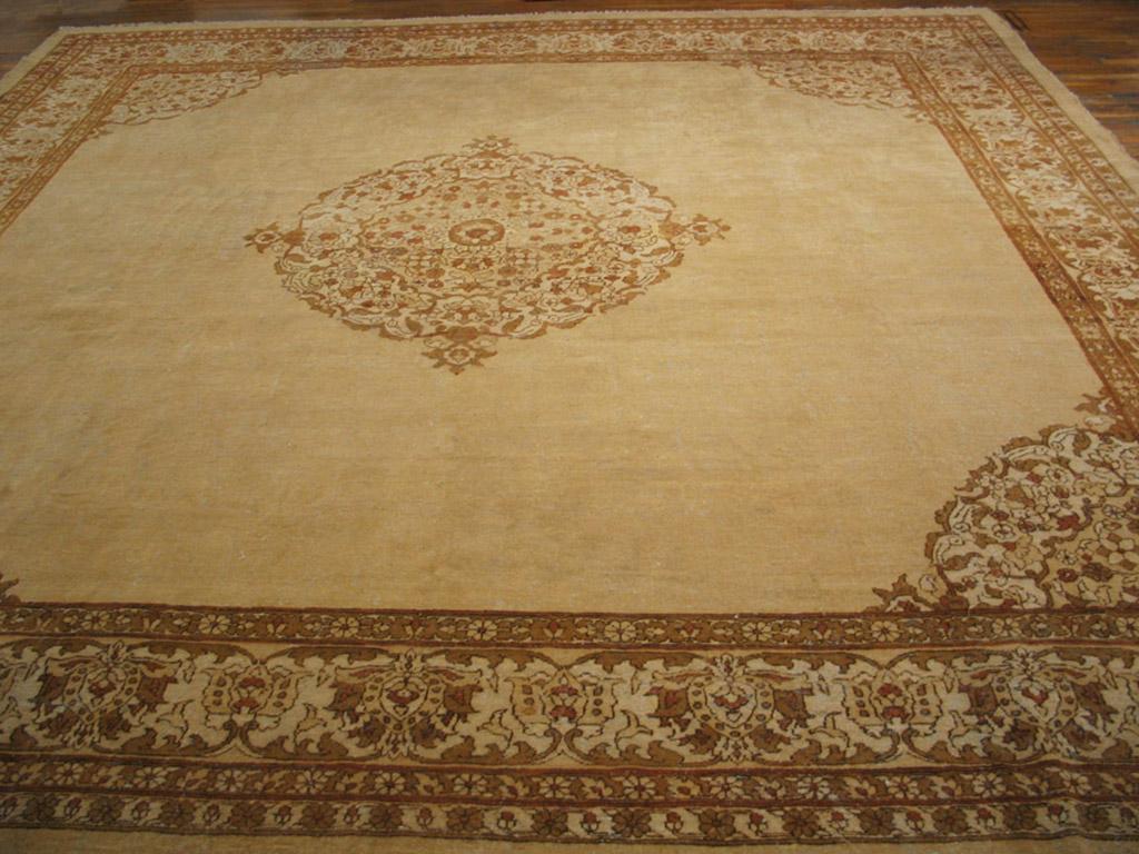 Square carpets are an Agra specialty and this decorative ivory open field carpet is an especially attractive example. The round, openwork medallion and matching corners are effectively located on a spacious undecorated ground in the Sultanabad