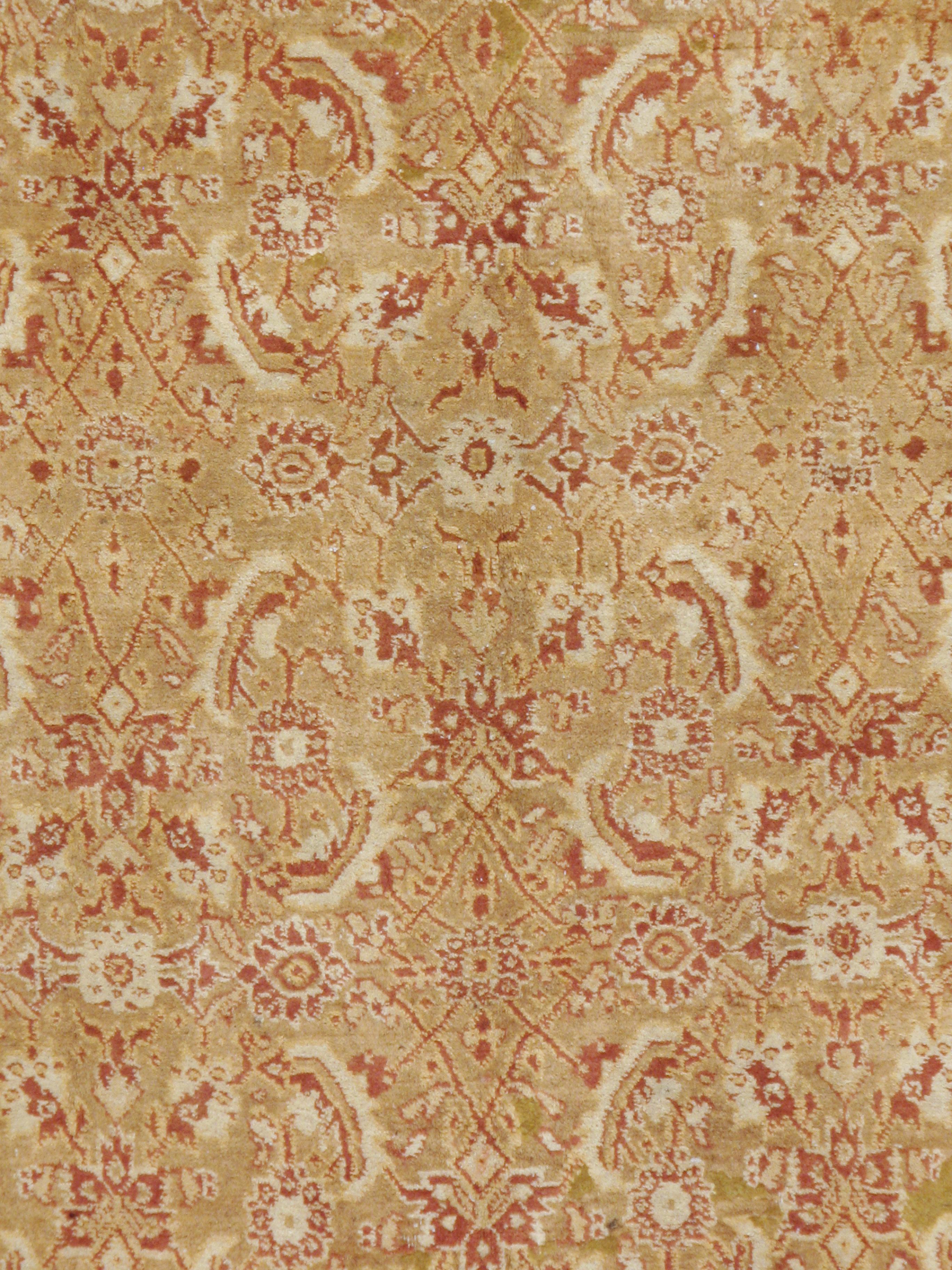 An antique Indian Agra rug from the early 20th century utilizing a large-scale rendition of the popular Persian 