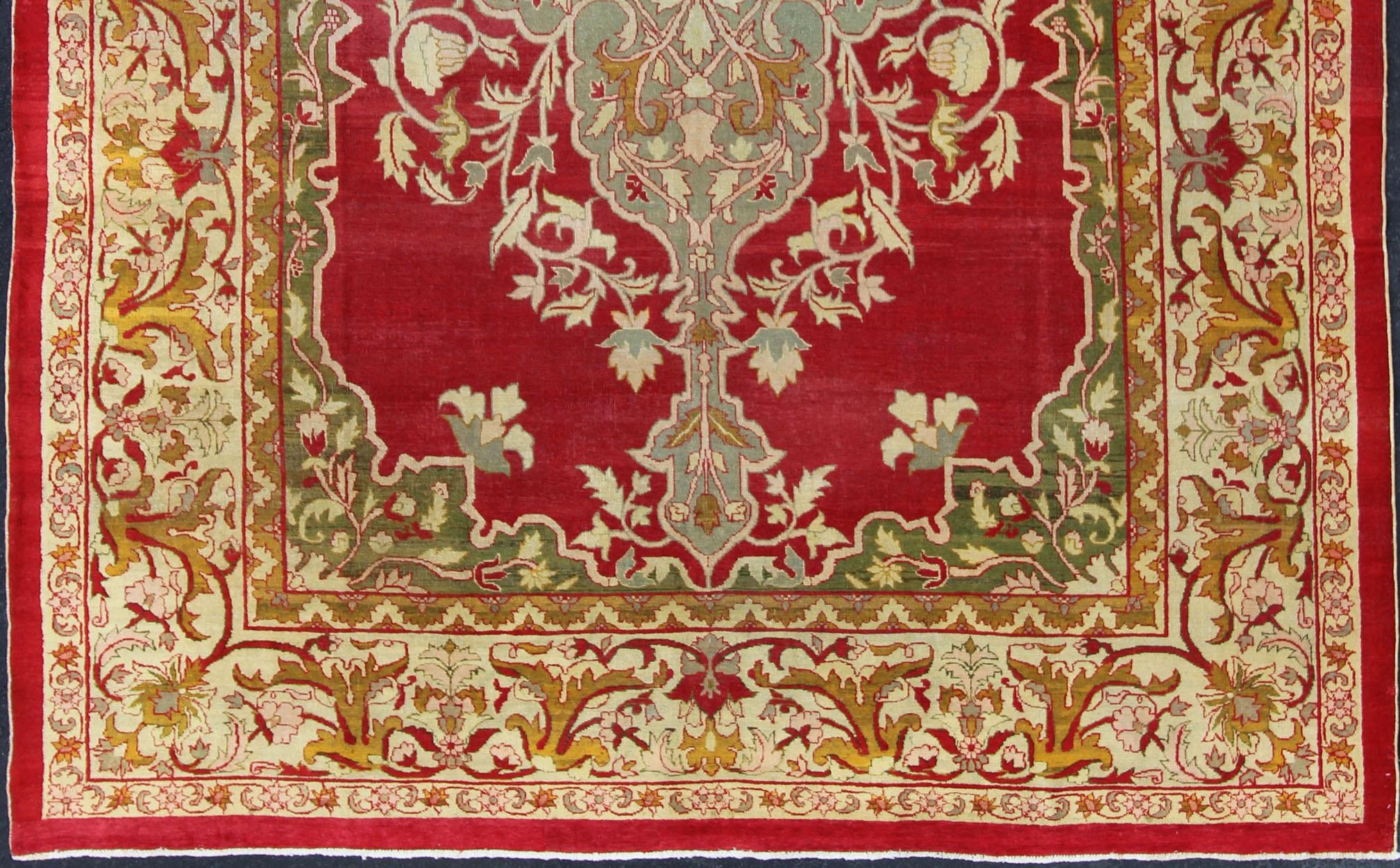       Indian Agra Antique Rug with Center Medallion in Green, Red, and Gold Colors. Keivan Woven Arts / 11-90208, circa 1910, Early 20-th Century Indian Agra

This outstanding Agra rug from the late 19th Century, with its bold design and color