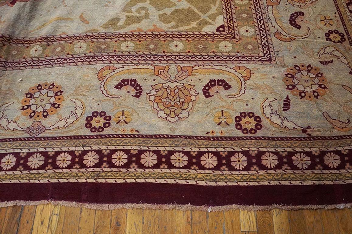 The rich cranberry lac red field of this impossibly striking Indian carpet has a design of ascending palmettes and lancet curved leavers of varying sizes and complexities in a “book-cover” shaped reserve, within ivory arabesque filled corners. The